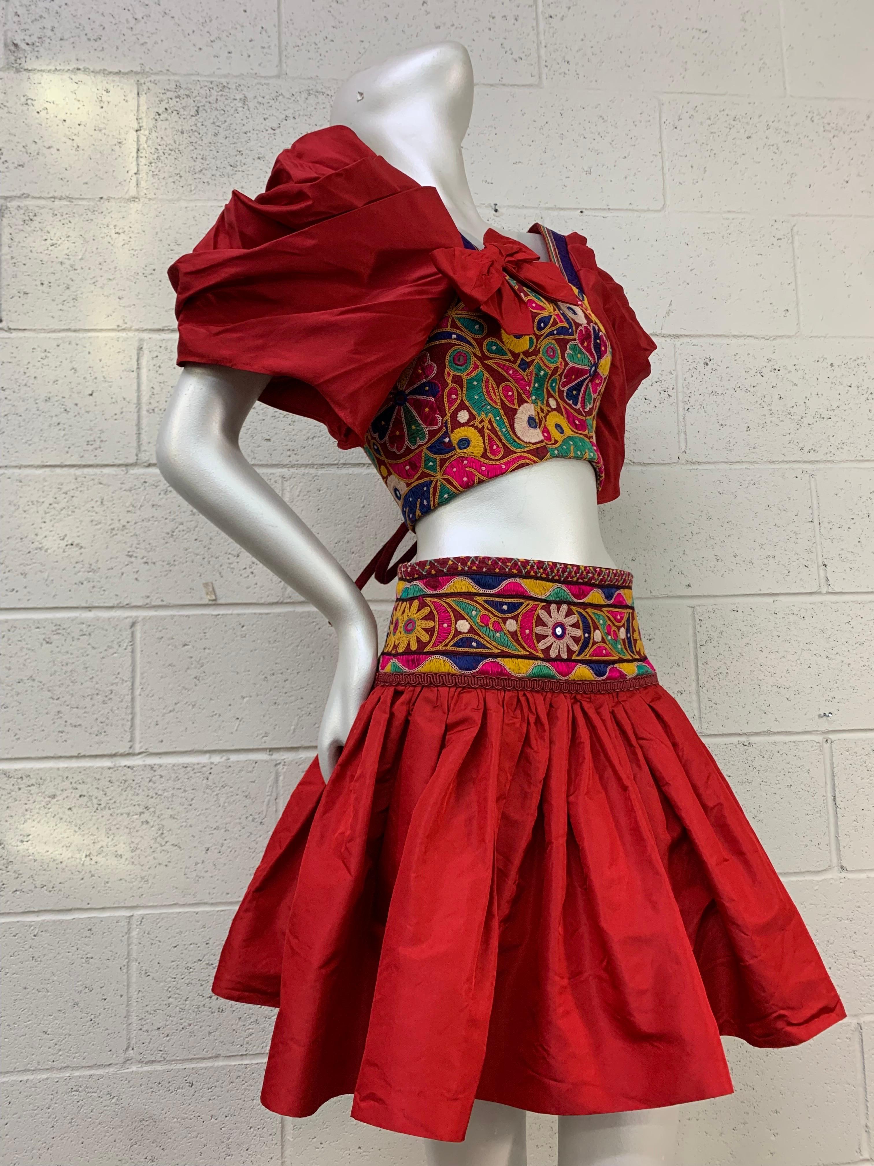 Torso Creations Crimson Silk Taffeta Mini Skirt & Corset-Style Blouse Ensemble: Indian floral embroidery with mirror insets contrasting with sleek silk in this fabulous Ensemble. Lacing up back of blouse. Skirt hooks on side to close with a wide