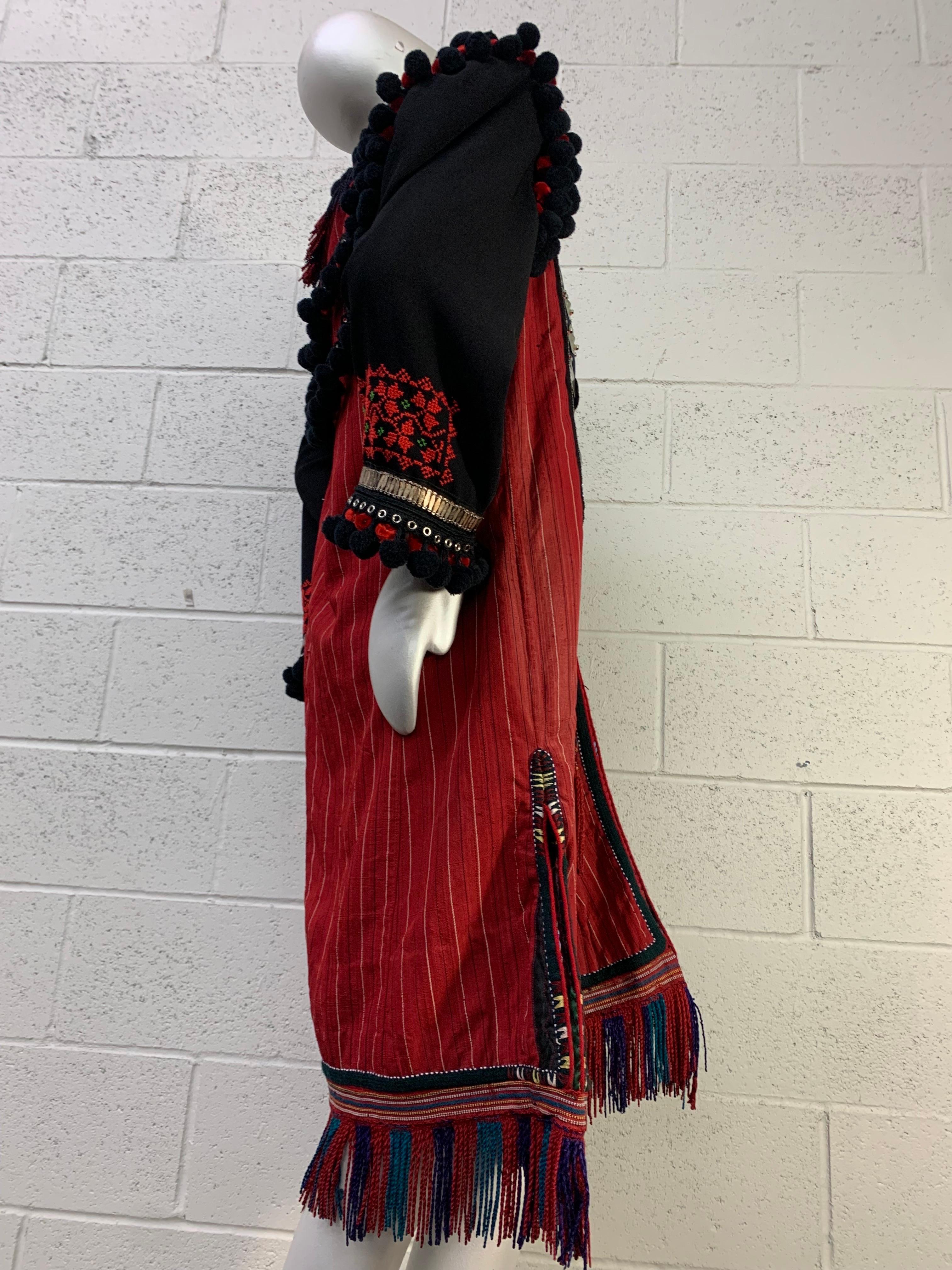 Torso Creations Folkloric Red and Black Cotton Ceremonial Coat w Silver Medallions & PomPom Fringe: Structured shoulders are topped with red and black pompoms. Hemline is fringed. Side slit pockets with embroidery. Coin silver traditional