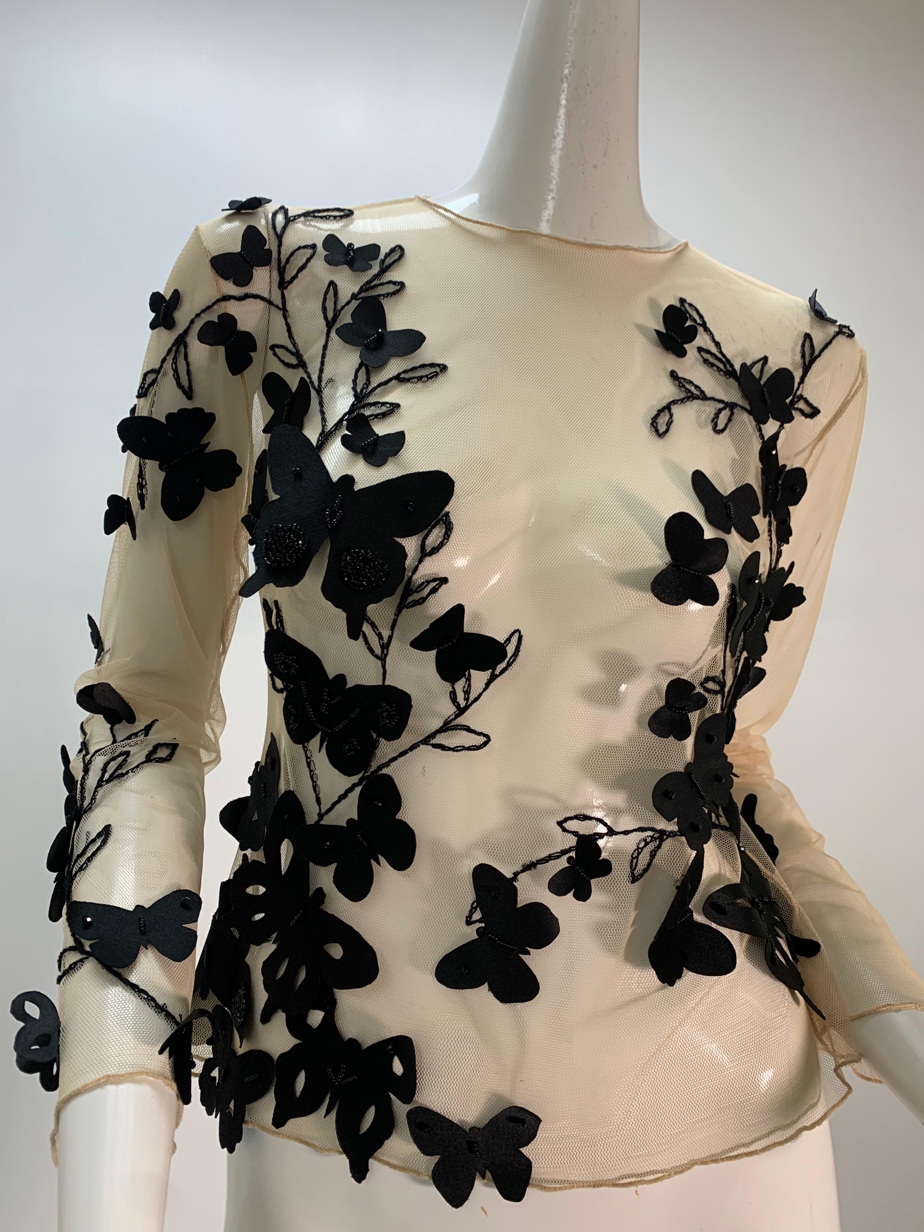 A Torso Creations ivory tulle long sleeved blouse embroidered with black leaf and branch silhouettes with silk satin butterfly appliques and beading. Unlined. 