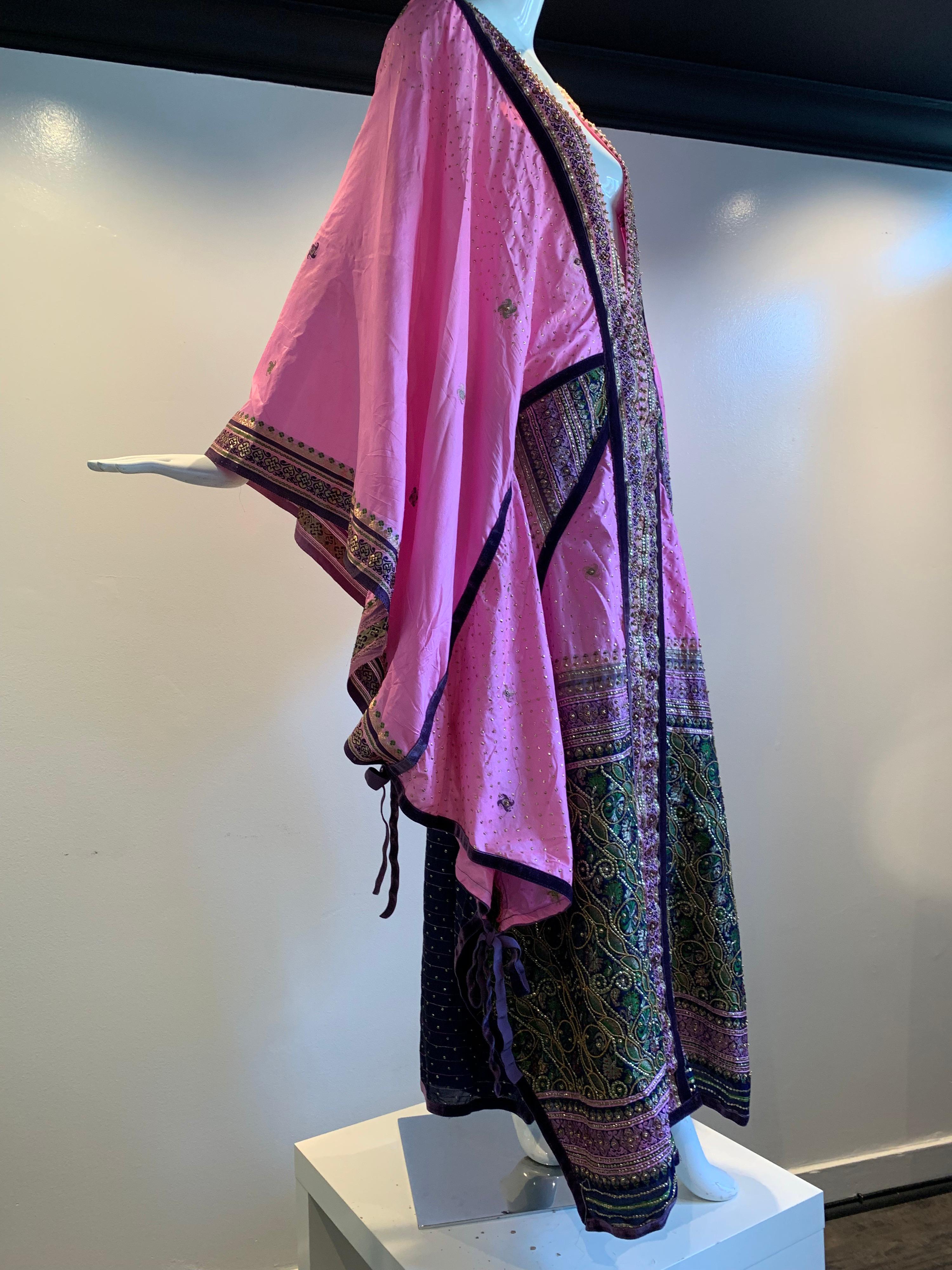 Torso Creations Pink Purple & Green Silk Caftan W/ Open Back, Embroidery, Purple Velvet Ribbon and Sequin Trim. Fashioned from vintage sari fabric in the style of Thea Porter. Adjustable drawstrings and ties. Deep plunging V- neckline. 