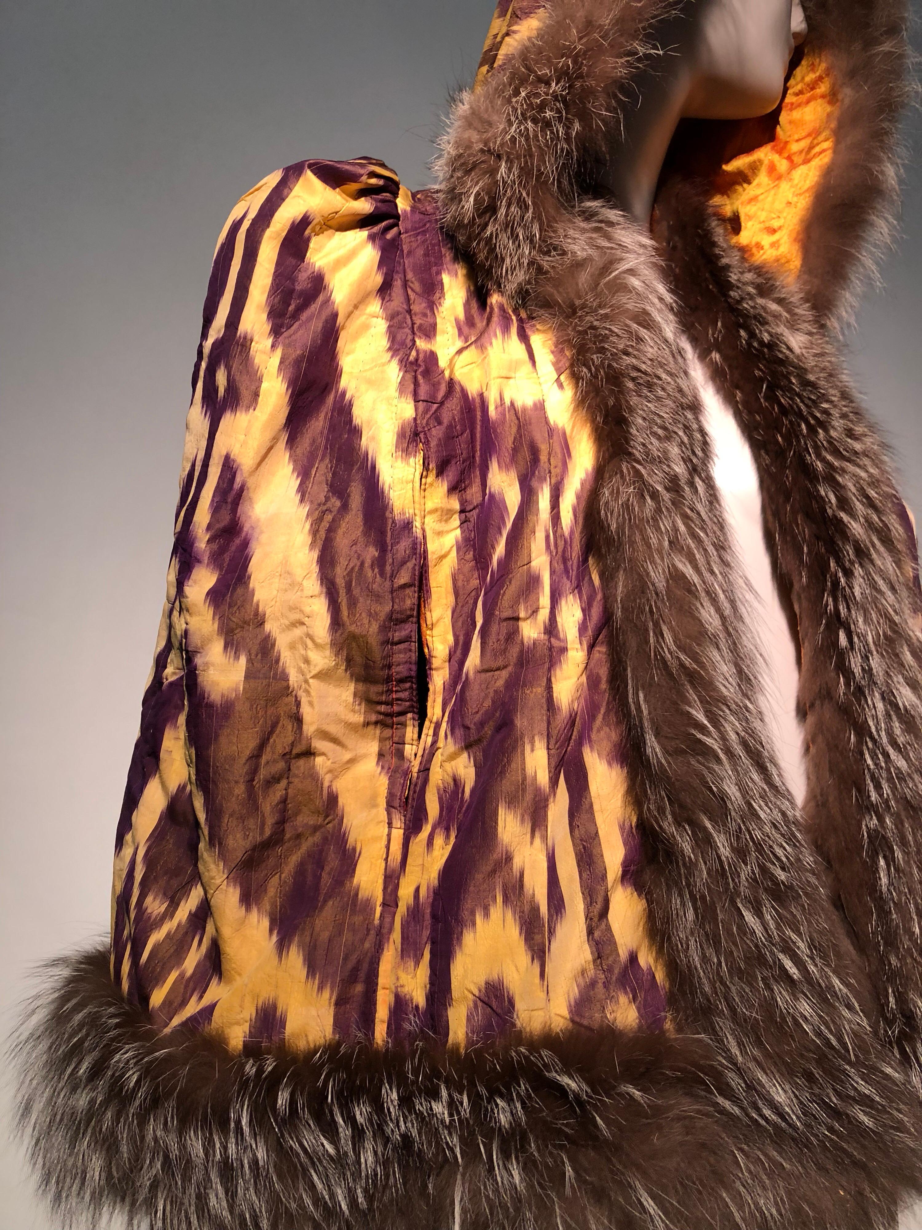 A beautiful Torso Creations tribute to 1930s style in this vintage-sourced yellow and plum silk Ikat woven hip-length caplet with a deep hood, shaped shoulders and luxurious natural silver fox fur trim. Lined in gold silk.