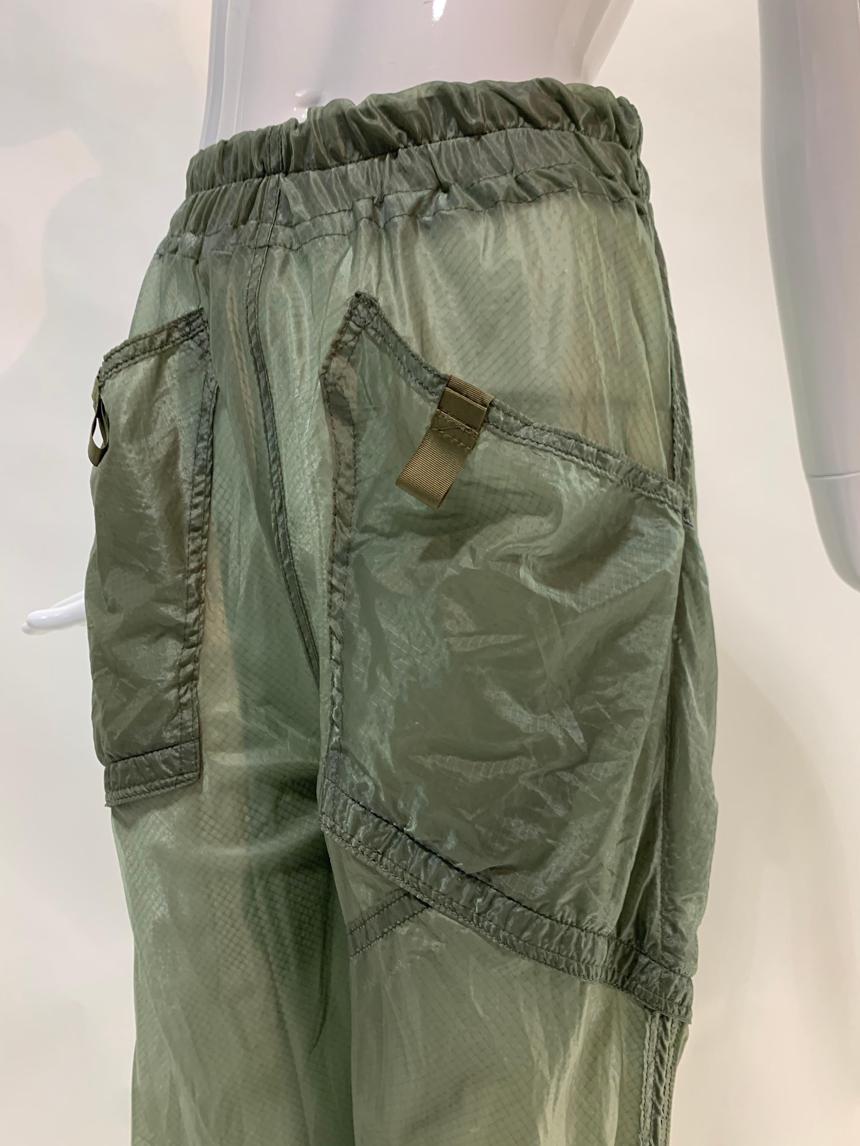Torso Creations vintage silk parachute fabric is upcycled to fashion sheer cargo pants with multiple pocket details at front and ankle. Elasticized waistband. Fits Small-Medium. A great bikini coverup for resort from our Spring/Summer 2022