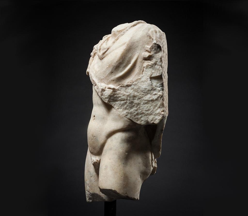 This torso represents an idealised version of the male form, and as such is both a handsome piece, and an interesting example of Imperial Roman taste of sculpture made in the Greek tradition. With a panther pelt draped over the right shoulder and