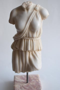 Female toga torso carved from white Carrara marble
