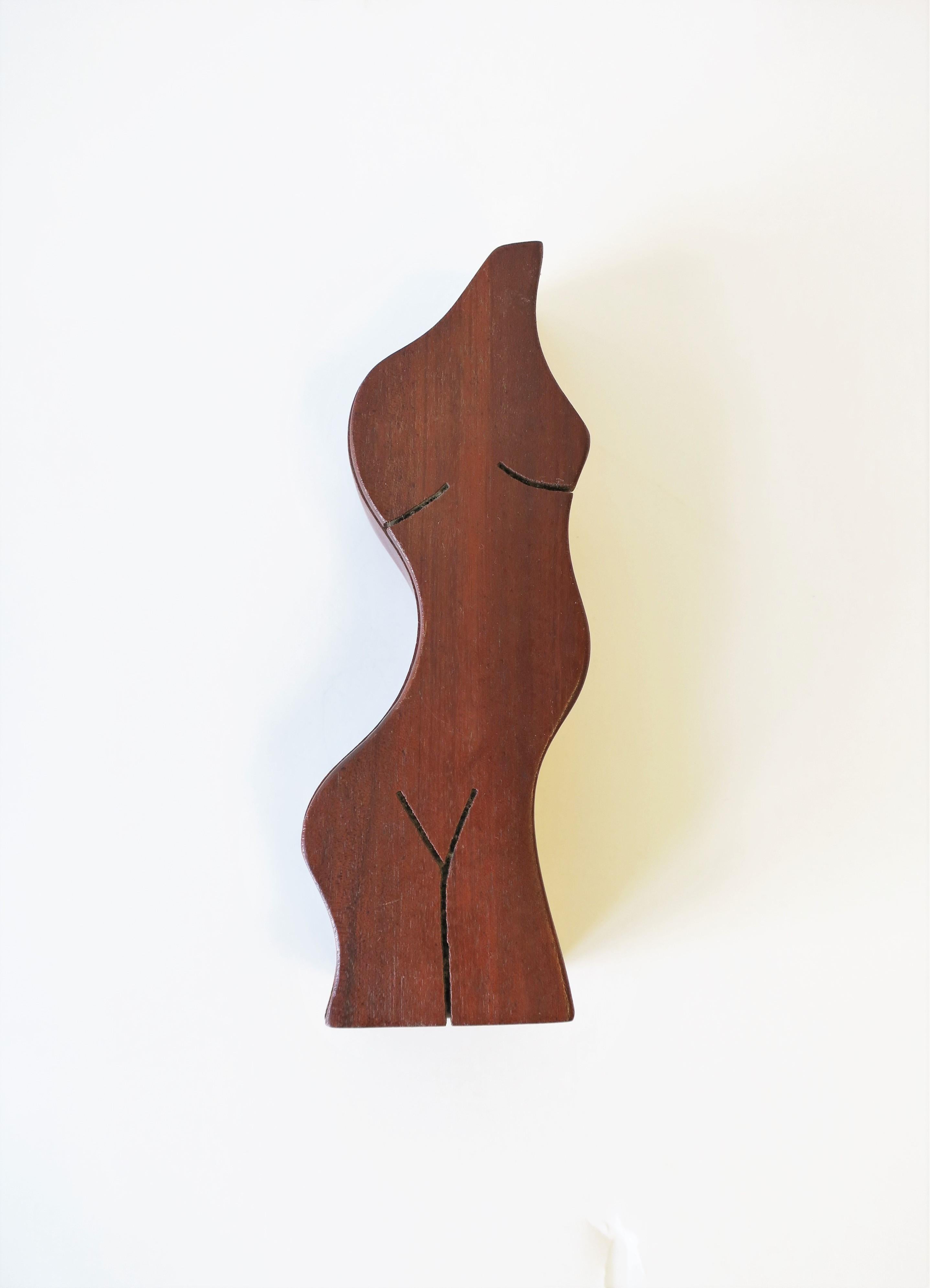 A beautiful shapely figurative wood box with female torso. Box works well as a standalone decorative piece, or can be used to hold jewelry or small items on a desk, vanity, console, or other area. Piece demonstrated as a jewelry box in images #5, 6,