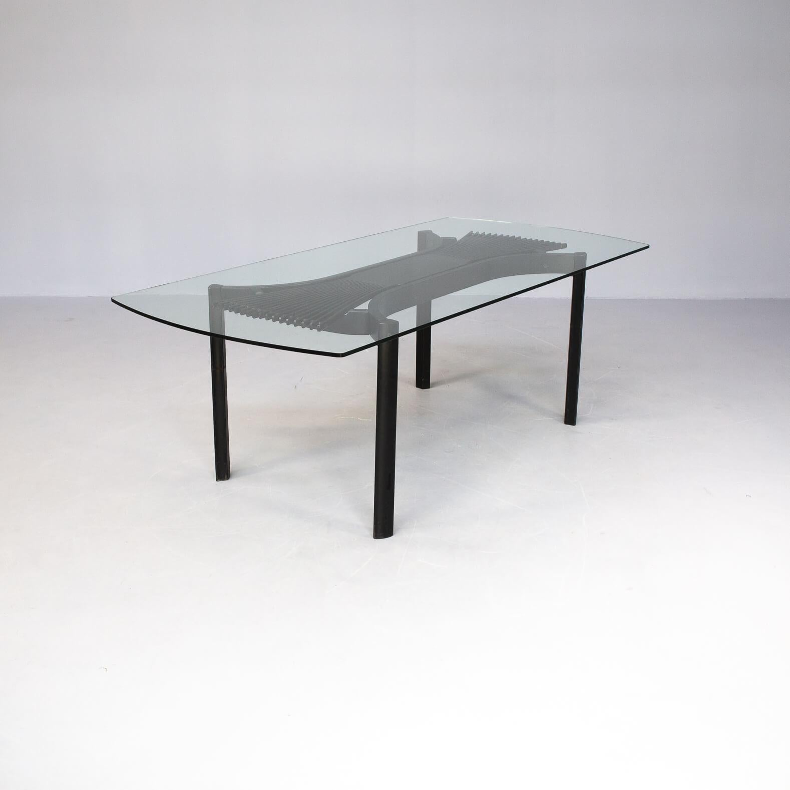 This rare glass dining table was designed in Norway in 1984 by Torstein Nilsen for Westnofa.
The table shows a frame in thin lines of very luxury and high quality made natural oak lacquered in black. The individual legs of the ‘fan form’ are