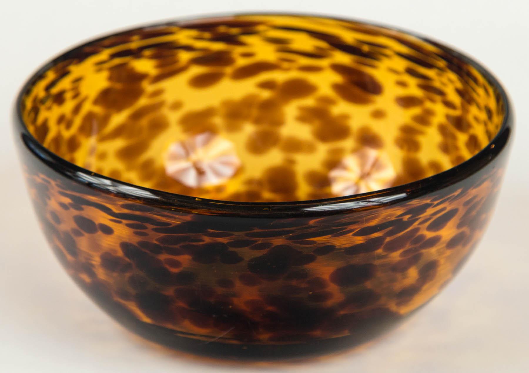 Tortoise shell art glass bowl, circa 1900, England. Tortoise shell art glass was patented in London in 1880 by Francis Pohl and S.A. Whitman. It is created by two layers of hand blown glass with pieces of light and dark brown glass between.