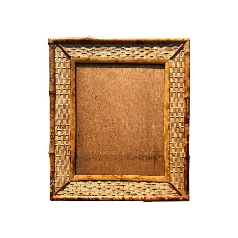 Scorched bamboo (commonly referred to as tortoiseshell or tiger bamboo) is a light brown and deep brown photo frame with scorched bamboo and raffia woven front. 

This beautiful photo frame stands at 14