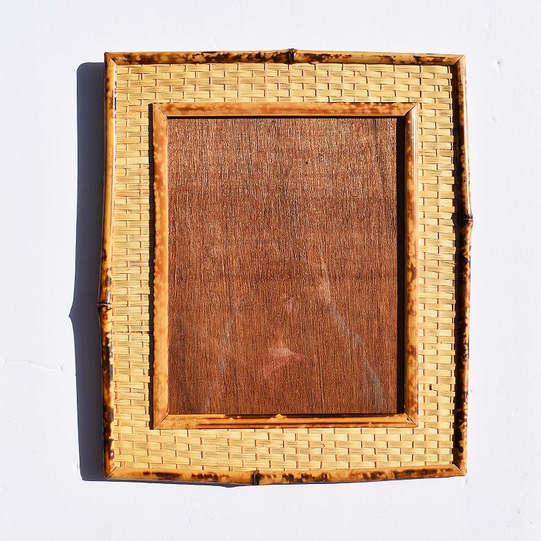 Scorched bamboo (or commonly referred to as tortoiseshell or tiger bamboo) light brown and deep brown photo frame with scorched bamboo and wicker exterior. 

This beautiful photo frame stands at 14