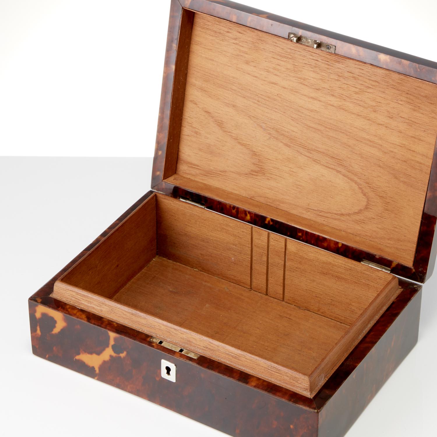A great looking cigar box mounted in silver with scroll decoration on the exterior of the box. The mounts are in a good gauge of silver.
The tortoiseshell is in excellent condition and retains its natural sheen and there is a good balance of light