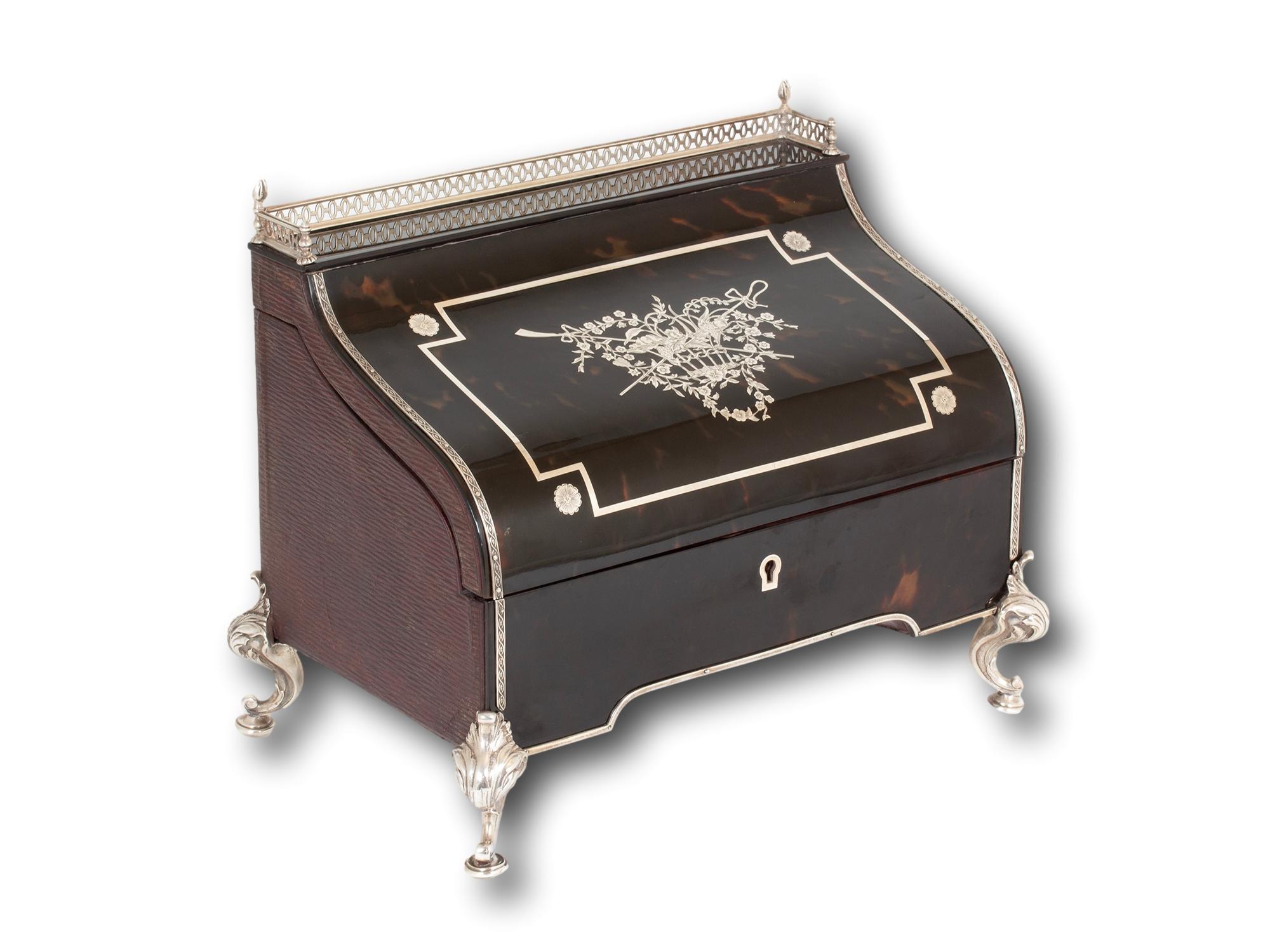 Raised on Four Sterling Silver Scrollwork Legs

From our Writing Box collection, we are pleased to offer this Tortoiseshell and Silver Stationery Box by William Comyns. The Stationery Box in the shape of a miniature Bureau Desk with fretwork silver