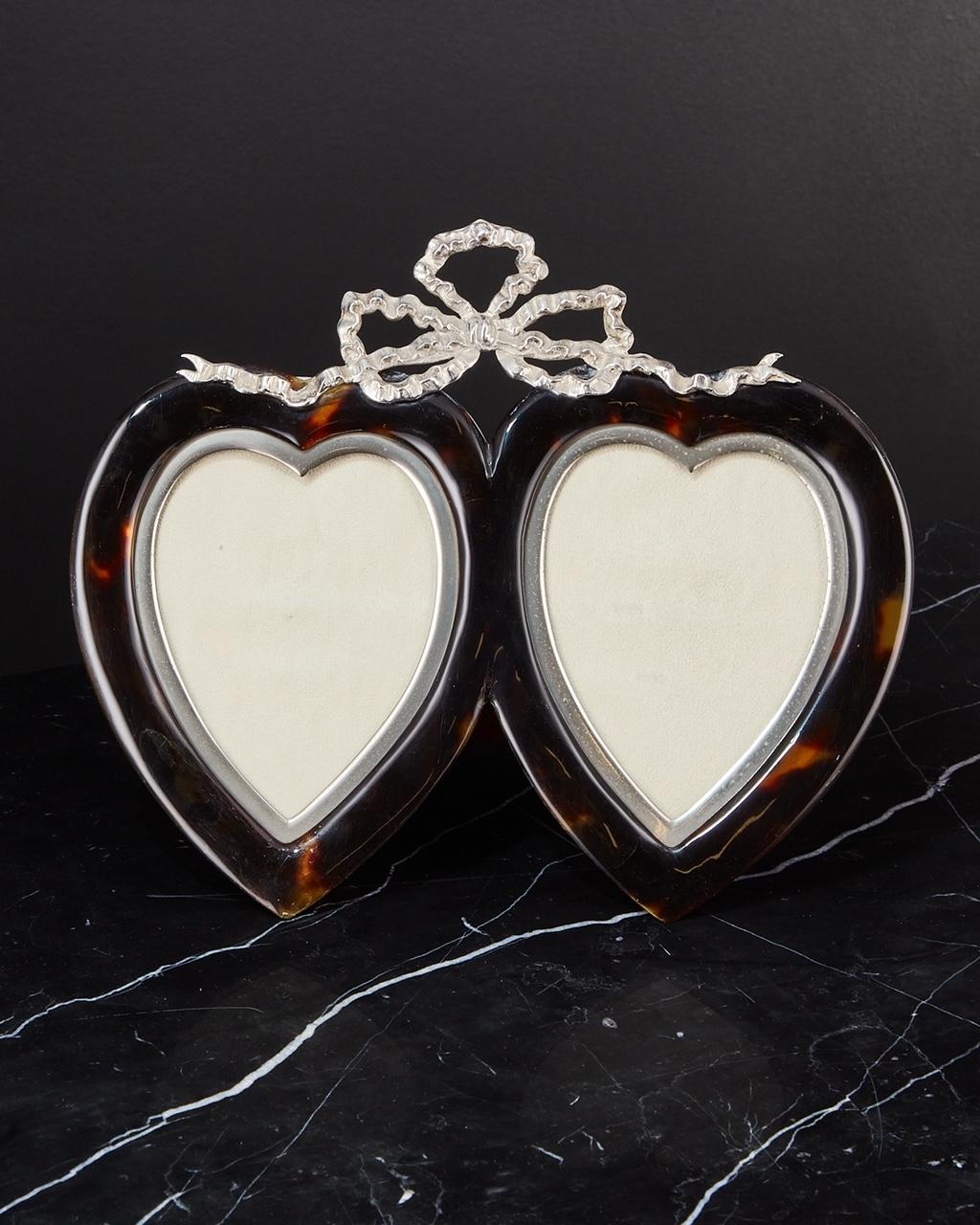 Tortoiseshell and silver heart photograph frame date London, 1897
Maker Henry John Batson & Albert Edward Batson 
This frame is in excellent condition the tortoiseshell retains its original patina, the cast silver surround and bow decoration set it