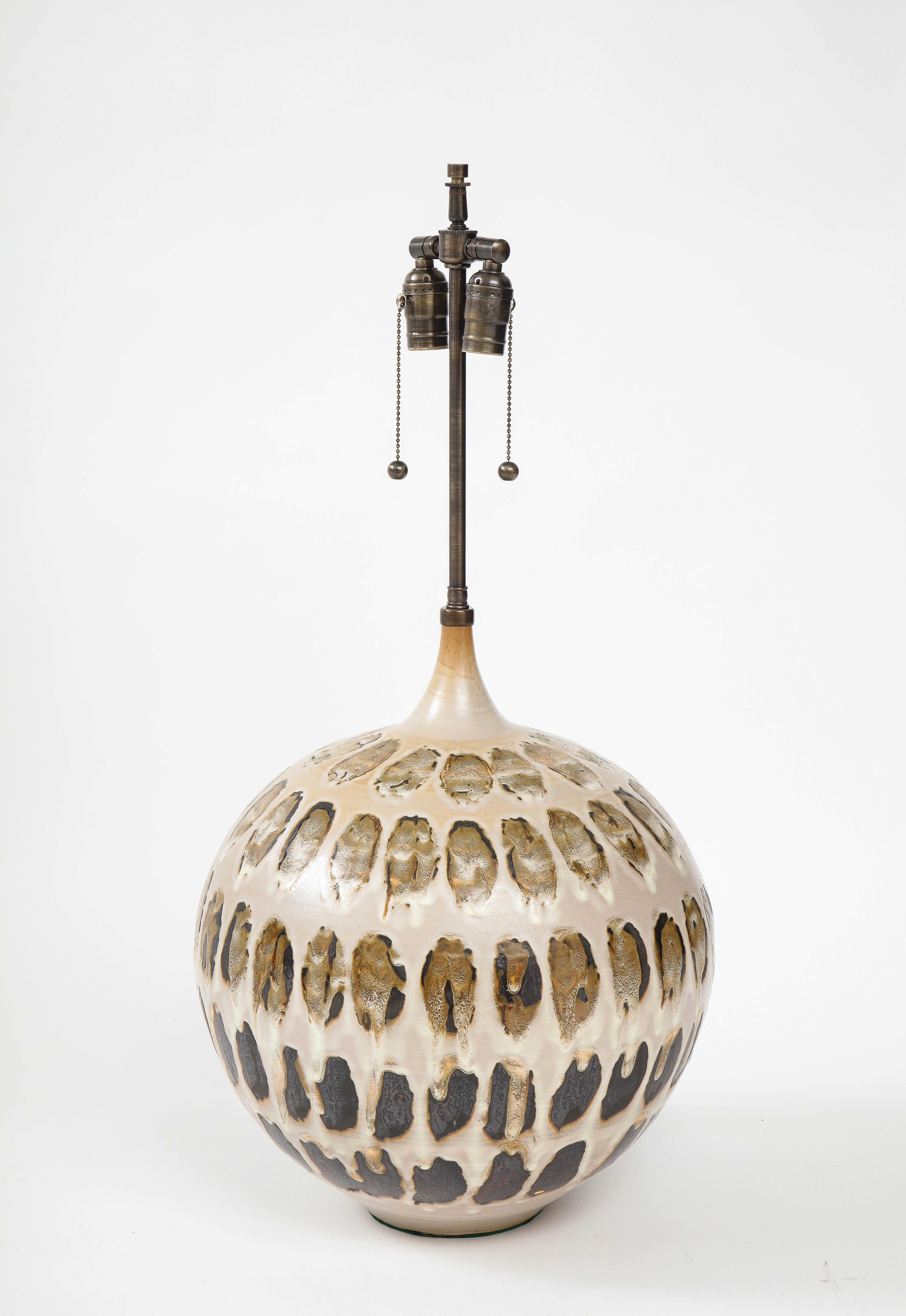 Large onion shaped bulbous lamp featuring a stunning stylized tortoise shell glazed pattern. Lamp has been rewired to US standards and has double pull chain sockets. 75W bulbs max for each socket.