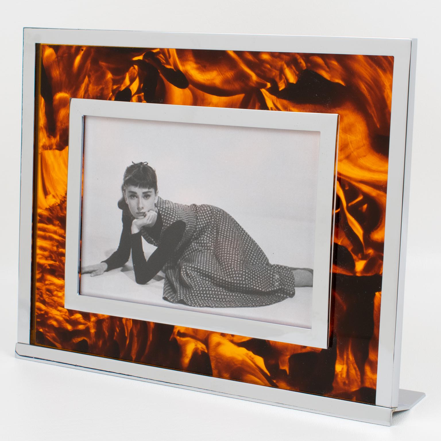 This impressive Italian Mid-Century picture photo frame is perfect for any modern or vintage home. The stunning easel-type table photo holder features a tortoise (tortoiseshell) textured pattern Lucite and chromed metal framing, giving it a classic