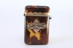Tortoiseshell matchbox with gold applications and button to open
