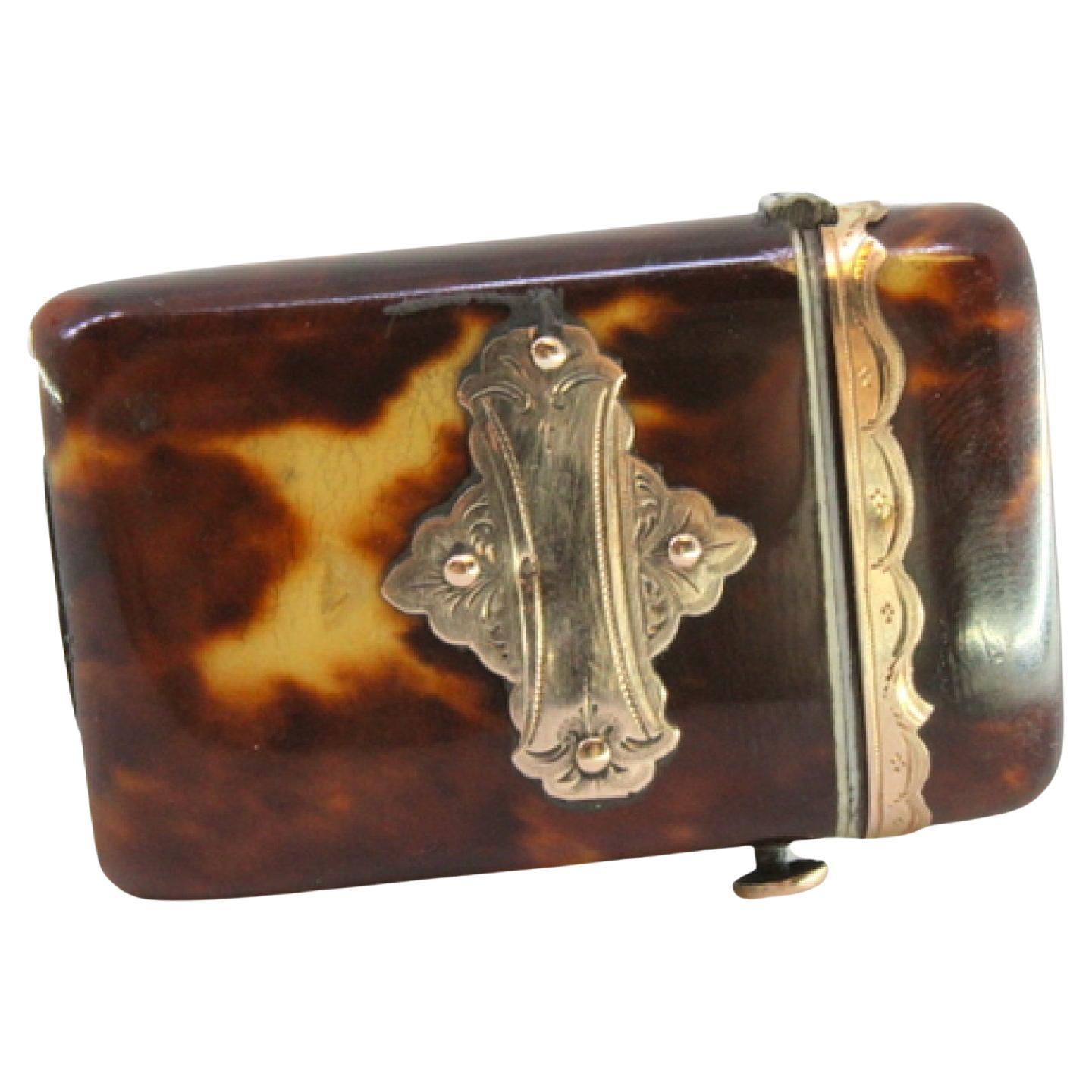 Tortoiseshell matchbox with gold applications and button to open