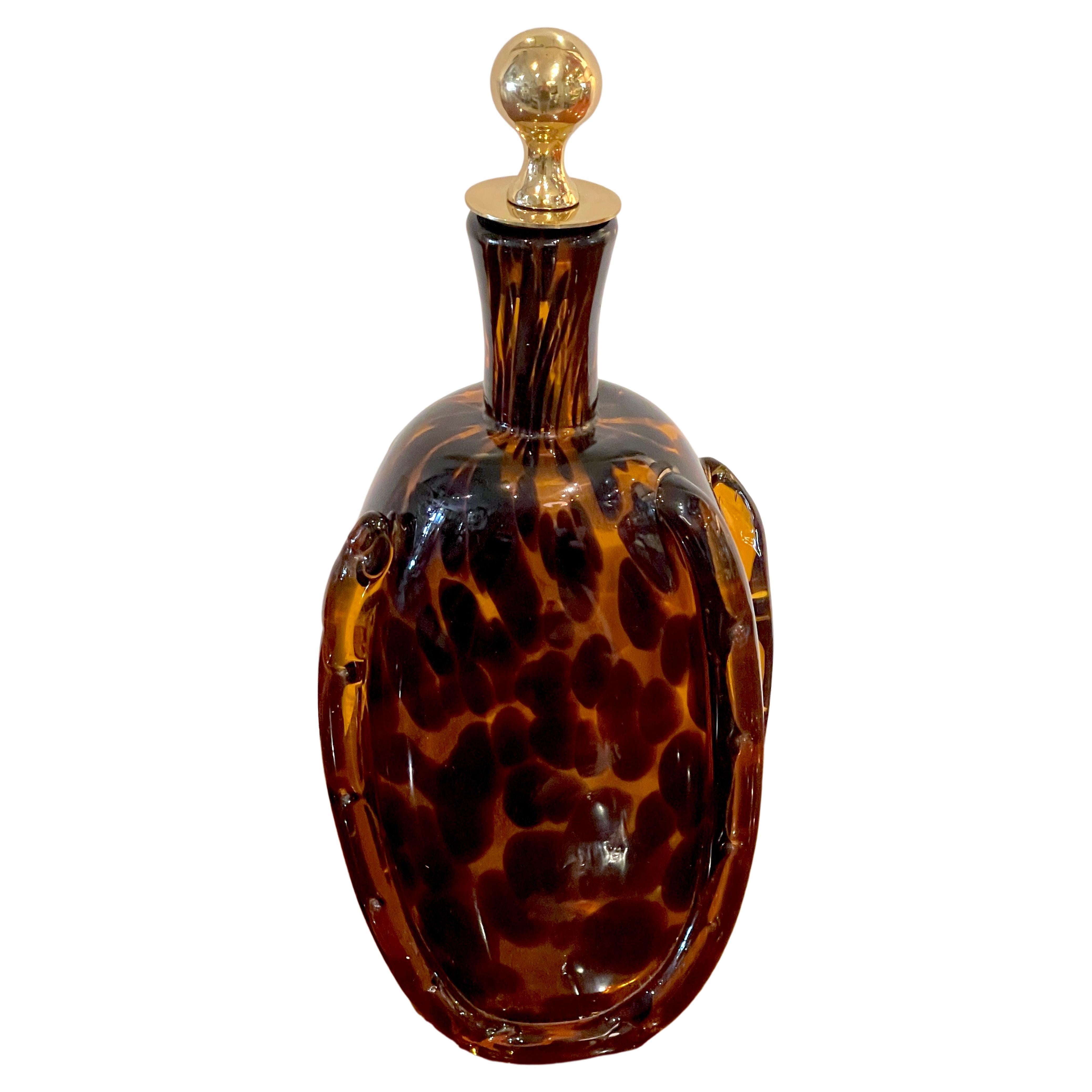 Tortoiseshell Murano glass & brass decanter, attributed to Barovier Toso.
Italy, 1950s
A beautiful example, fitted with its original 2-inch cast brass and cork stopper, the bottle is hand blown in a deep rich earth tones to resemble tortoise