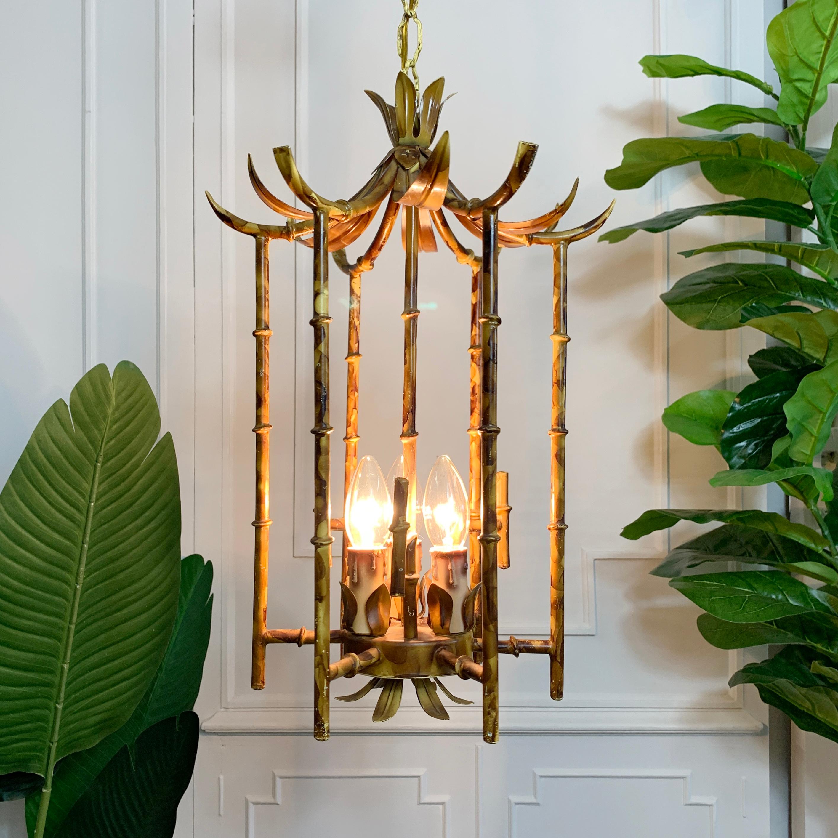 French 1960’s Chinoiserie Faux Bamboo chandelier, hand painted tortoiseshell on metal in the form of a Pagoda. The lamp is very much in the manner of Maison Bagues, delicately detailed bamboo stemmed cage, surrounds three lamp holders that sit