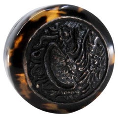 Tortoiseshell pill box with embossed silver application on the removable lid