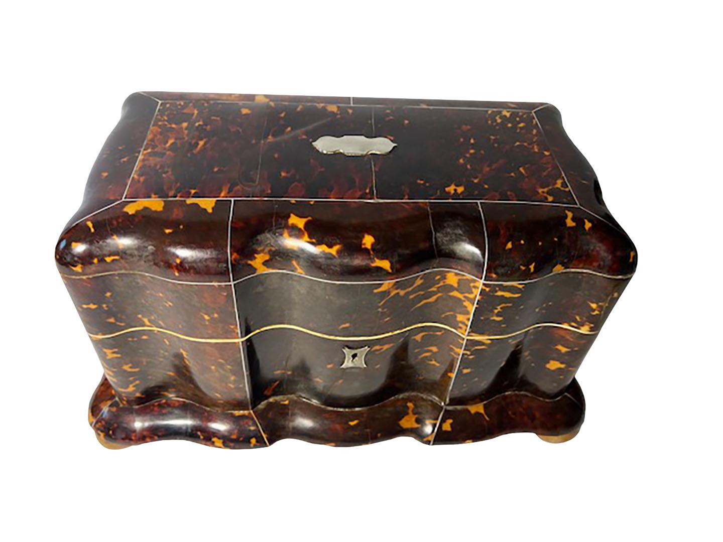 A very large faux tortoiseshell tea caddy from England. Lovely shape and sterling plate on top this hasn't been monogramed. Sitting on ball feet, circa 1860.