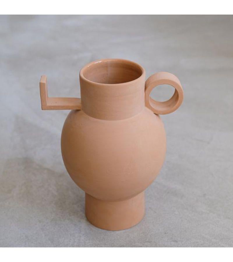 Torus Terracotta vase by Lea Ginac
Unique Piece. 
Dimensions: diameter 23 x height 30 cm 
Materials: Natural clay. Rough exterior, transparent enamel interior.
Technique: Hand-modeling.
Available in two colors, terra cotta, and white.