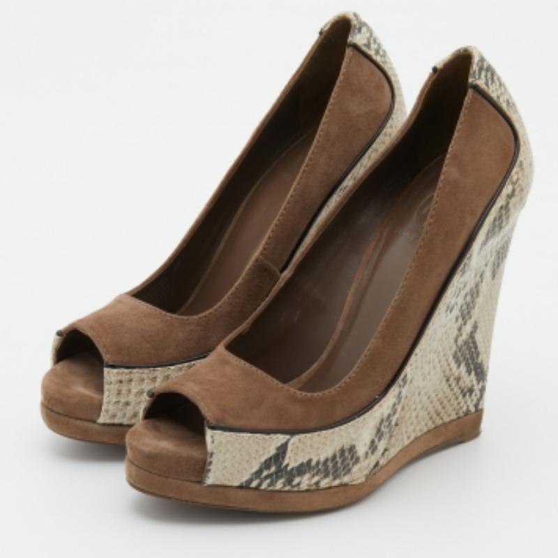 Exhibit an elegant style with this pair of pumps. These designer pumps are crafted from quality materials. They are set on durable soles and high heels.