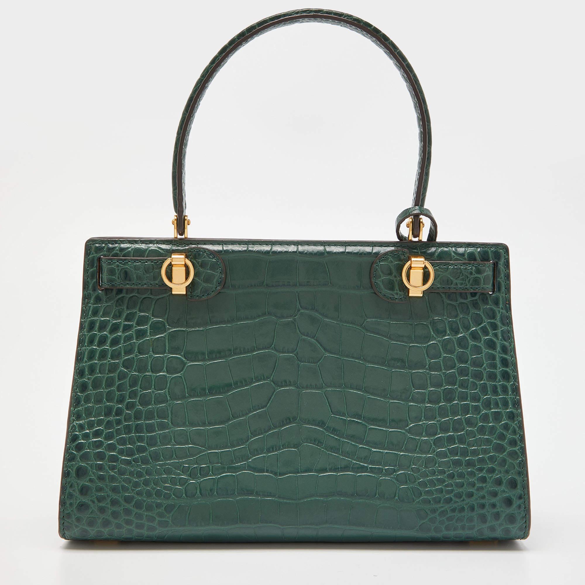 Tory Burch's Lee Radziwill Satchel is updated in gorgeous green croc-embossed leather. Detailed with gold-tone hardware, this bag comes fitted with a slim top handle. Set on protective base studs, this bag is secured with a gold-tone lock. The