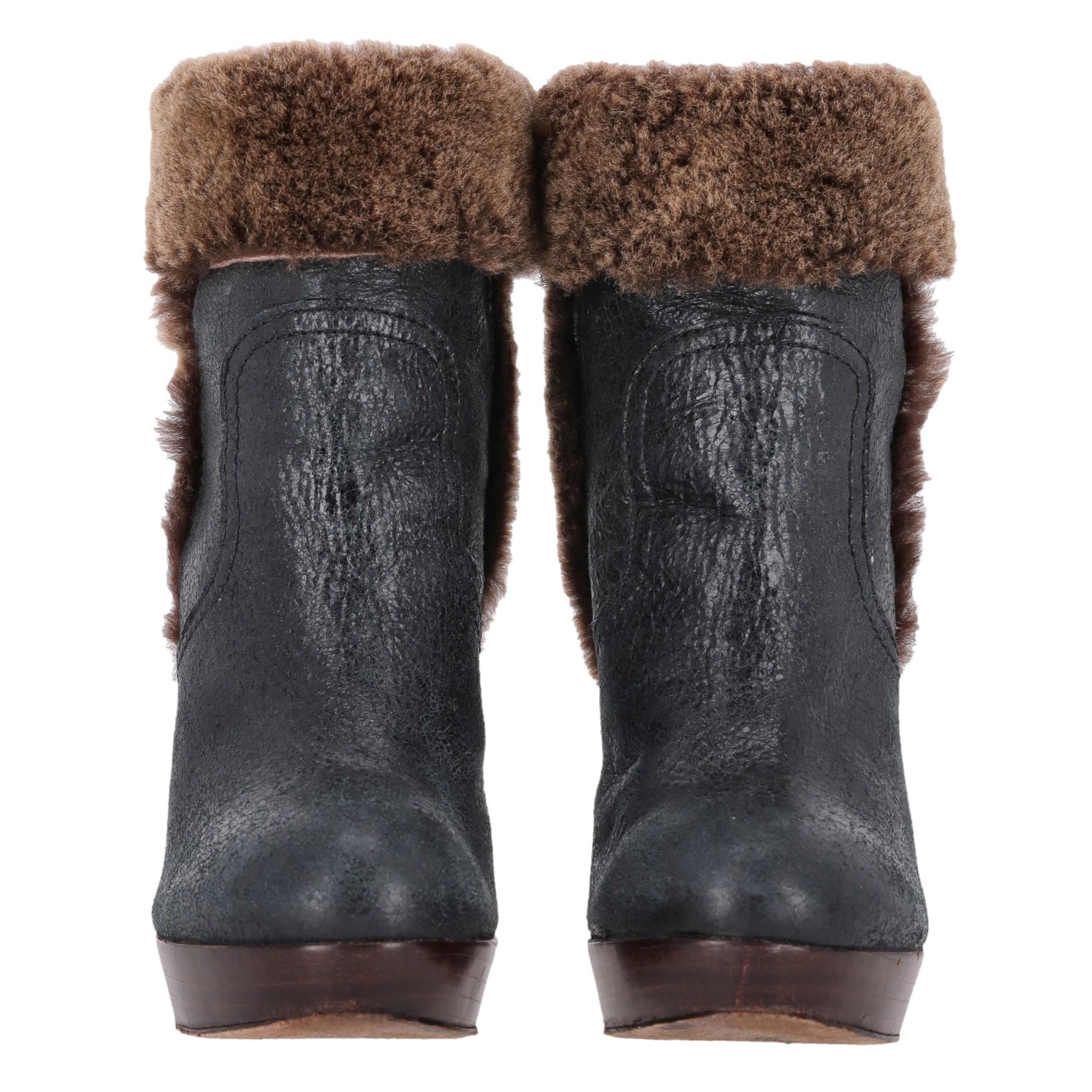Tory Burch Leather & Shearling Sebastian Ankle Boots

Black ankle boots crafted from leather with brown shearling trim.

Detailed with logo embossed patch at heel cap, pull-on design and almond toe.

Featuring stacked platform and high, block heel.