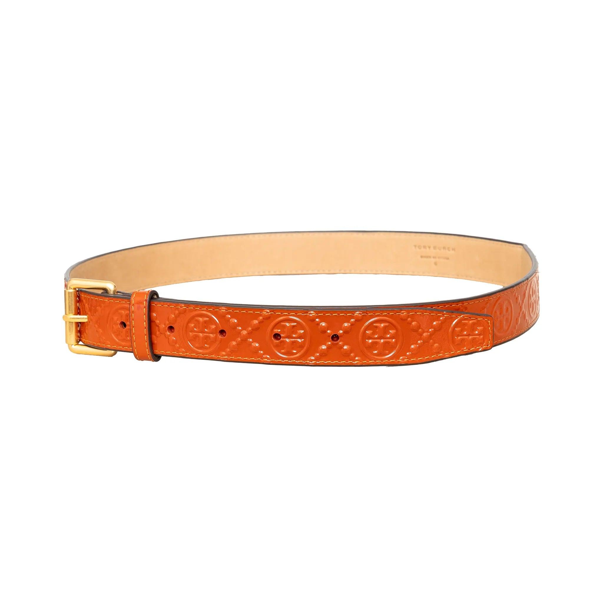 Cintura Tory Burch in pelle verniciata color arancio terracotta, con logo in rilievo e finiture dorate per una finitura audace e raffinata. 
 Materiale: Pelle 
 Misure: Width:2.5;Length:94;Waist:72-87