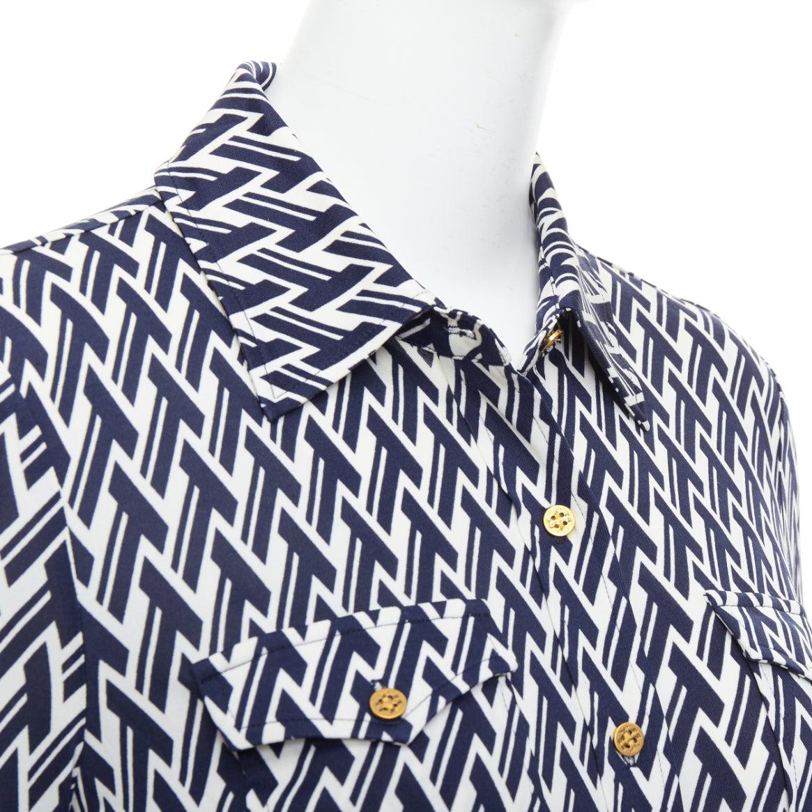 TORY BURCH navy cream T monogram print silk blend shirt XS
Reference: SNKO/A00469
Brand: Tory Burch
Material: Silk, Blend
Color: Navy, Cream
Pattern: Monogram
Closure: Button
Extra Details: Gold logo buttons.
Made in: China

CONDITION:
Condition: