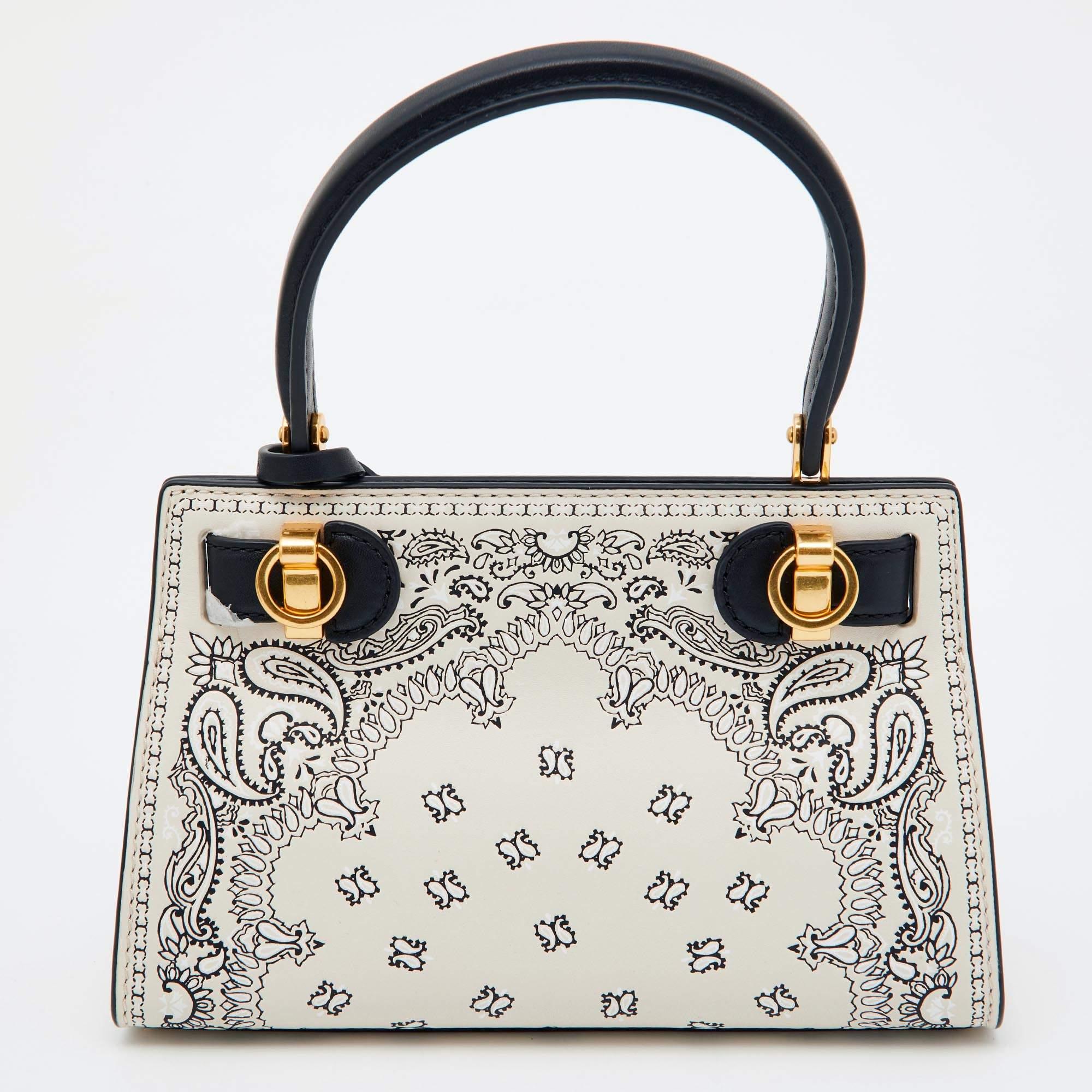 Indulge in luxury with this Tory Burch bag. Meticulously crafted from premium materials, it combines exquisite design, impeccable craftsmanship, and timeless elegance. Elevate your style with this fashion accessory.

Includes: Original Dustbag,