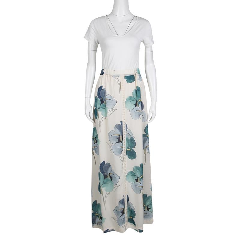 For days when you feel like strolling on the beaches and lounging in resorts, wear this Kendra maxi skirt from Tory Burch. It is crafted with silk in an off-white color and painted with beautiful blooming irises. The unique feature of this piece is