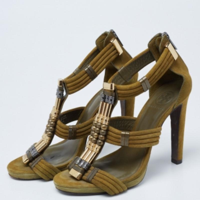 Take every step with elegance and style in these gladiator sandals from Tory Burch. They are crafted using olive-green suede, which is embellished with beaded accents. They showcase open-toes, gold-tone hardware, and block heels. These sandals will