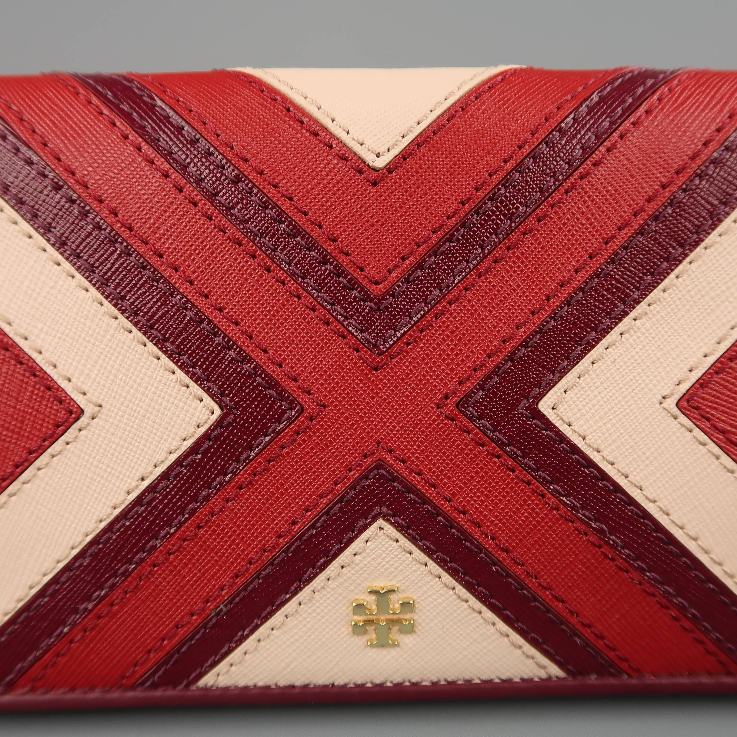 TORY BURCH wallet comes in red, plum, and pink patchwork pattern leather with a zip closure and internal compartment storage.
 
New with tags.
 
Measurements:
 

    Length: 7.5 in.
    Width: 1 in.
    Height: 4 in.

