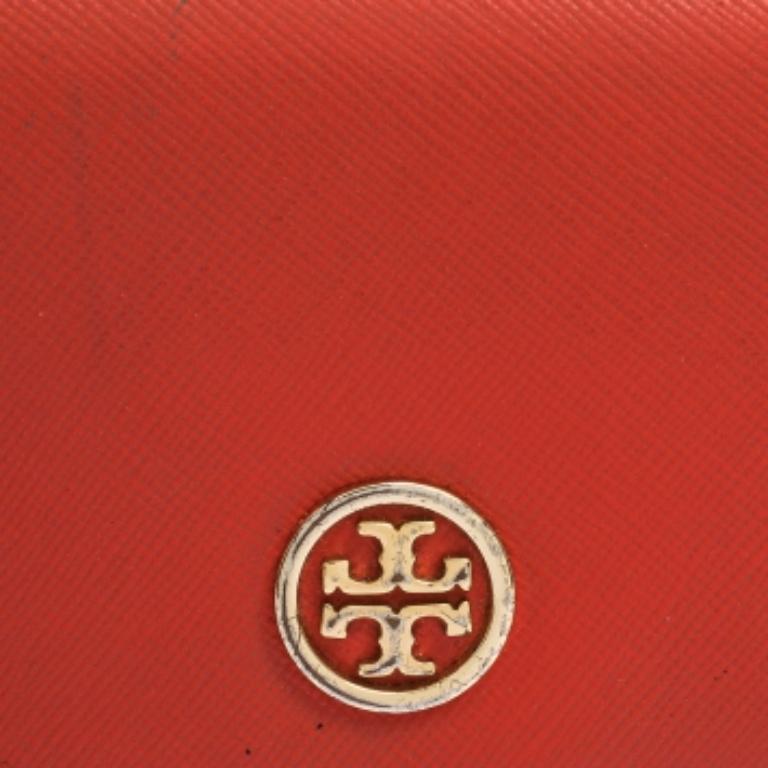 Made of red leather, this continental wallet from Tory Burch is a classy choice. The flap opens elegantly to an interior with multiple card slots and a zipped pocket. This wallet is complete with the logo on the front.