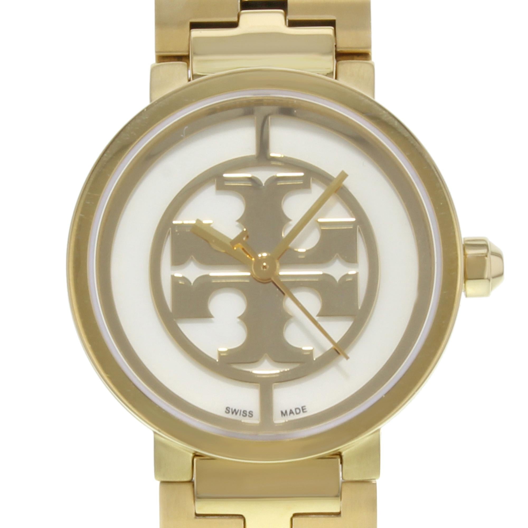 This pre-owned Tory Burch Reva TRB4011 is a beautiful Ladies timepiece that is powered by a quartz movement which is cased in a stainless steel case. It has a round shape face, dial and has hand unspecified style markers. It is completed with a