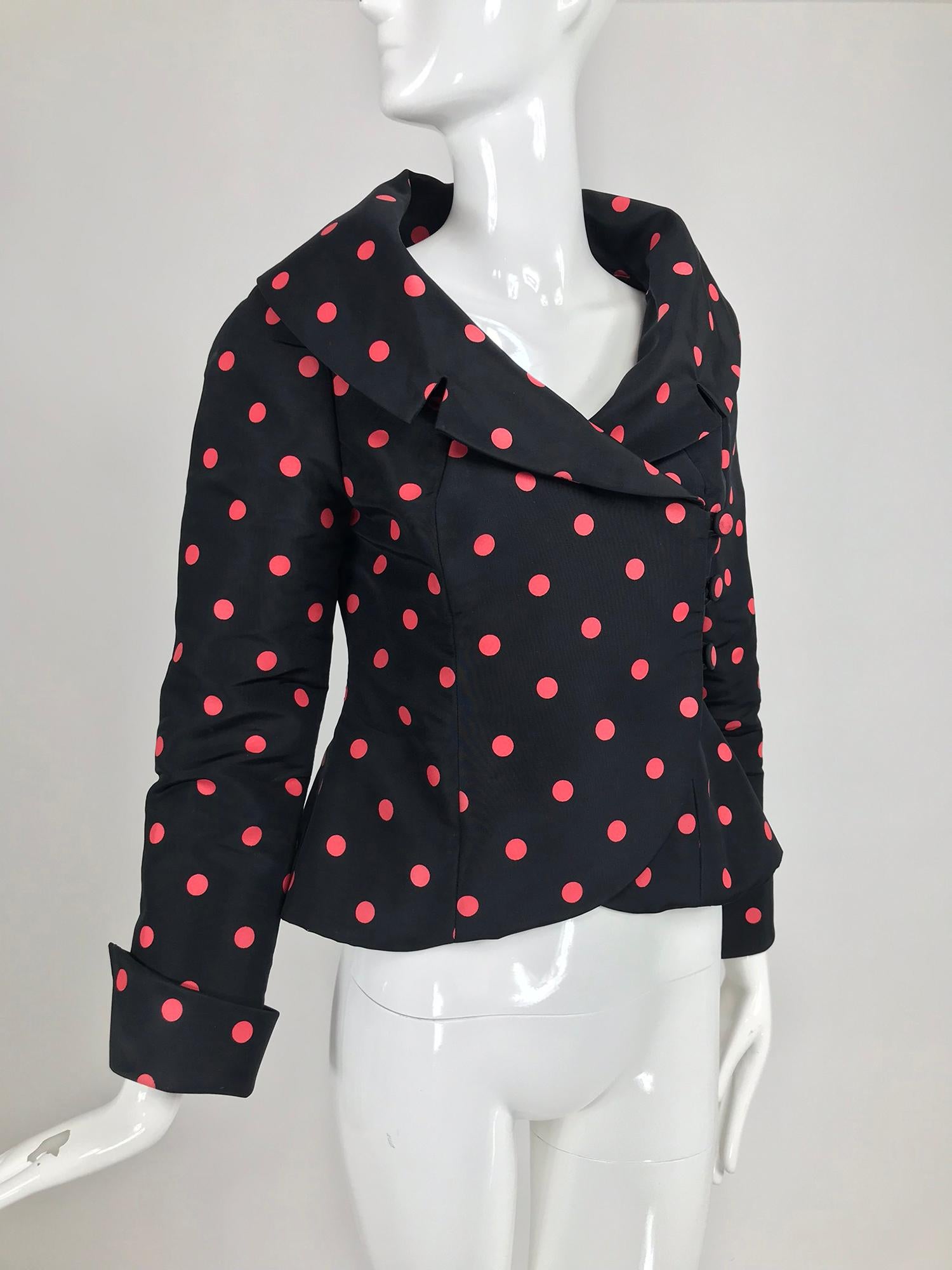 Tosca Couture black and red dot silk taffeta jacket. Portrait neckline with notched lapels, princess seam jacket is fitted through the waist and flares at the hip. The jacket buttons at the front side with buttons and loops. The jacket has long