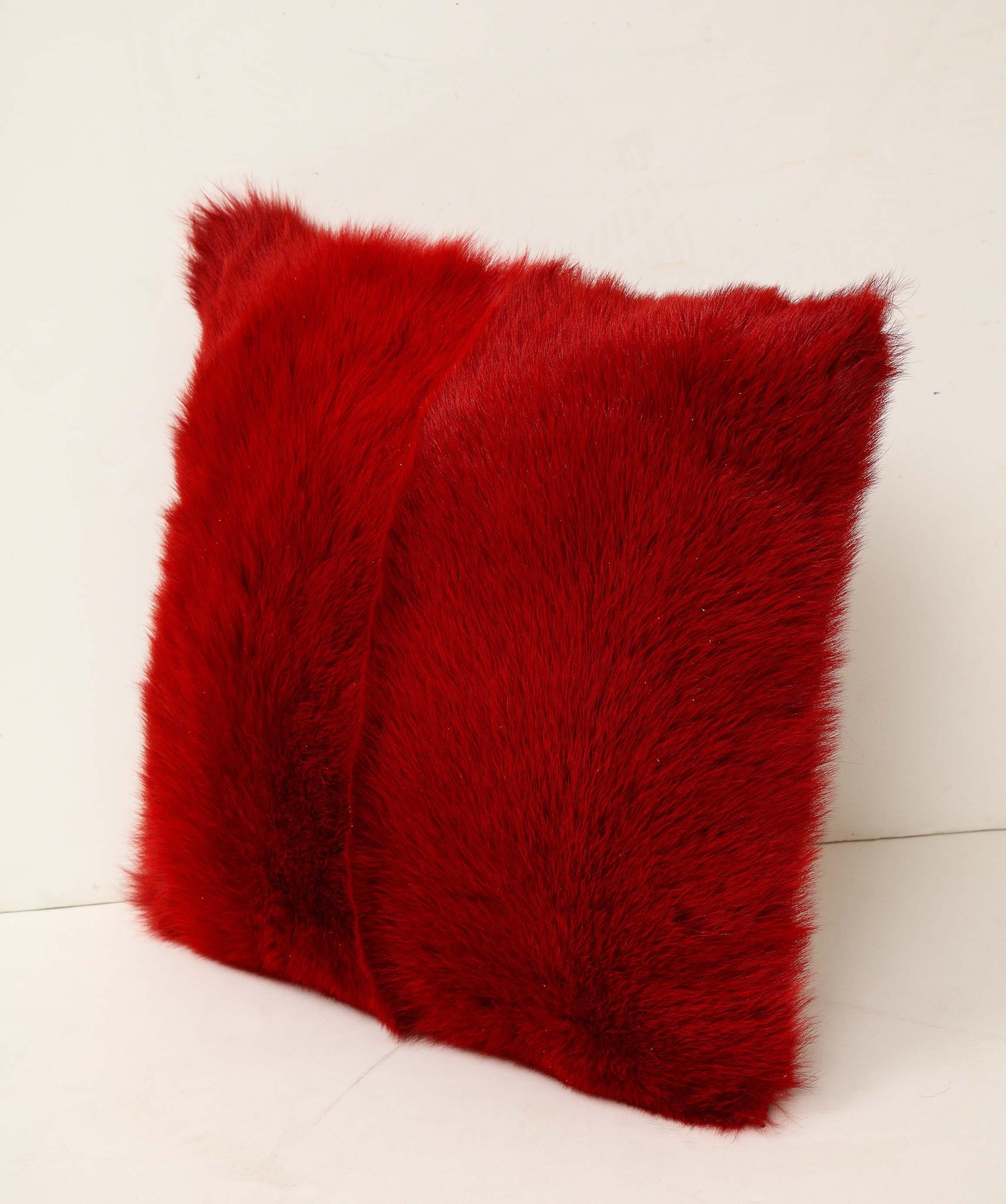 Custom ravishing Toscana long hair shearling pillow in red color with matching red colored leather backing. Soft and smooth in touch. It is made of genuine shearing with a zipper enclosure in a matching color, filled with down and feather, and 18