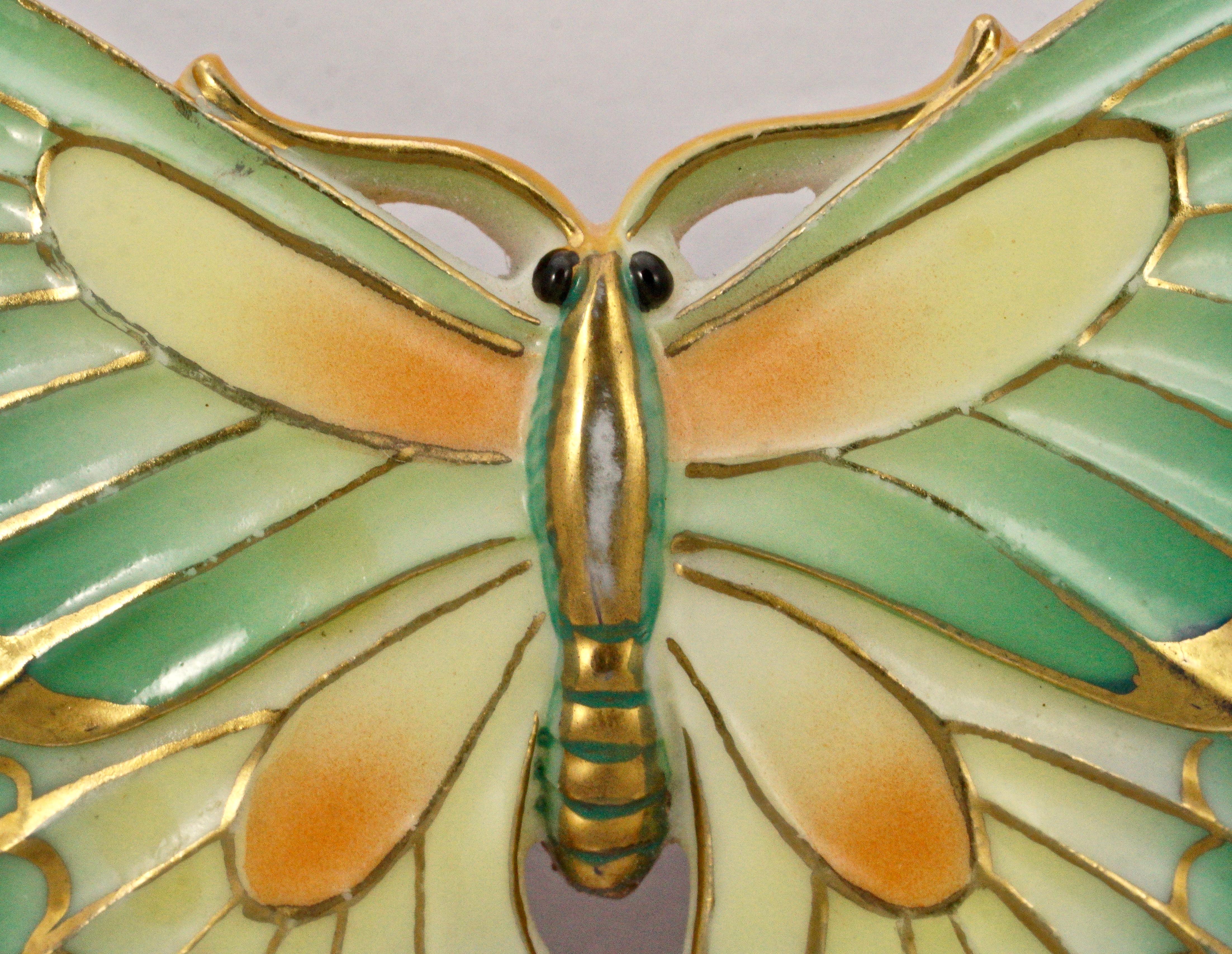 Toshikane Japan exquisite porcelain butterfly brooch, featuring vibrant green, yellow, and orange enamel with gold, blue and red highlights, all done by hand. The back is silver tone. Measuring maximum width 5.2cm / 2.04 inches by length 3.8cm / 1.5