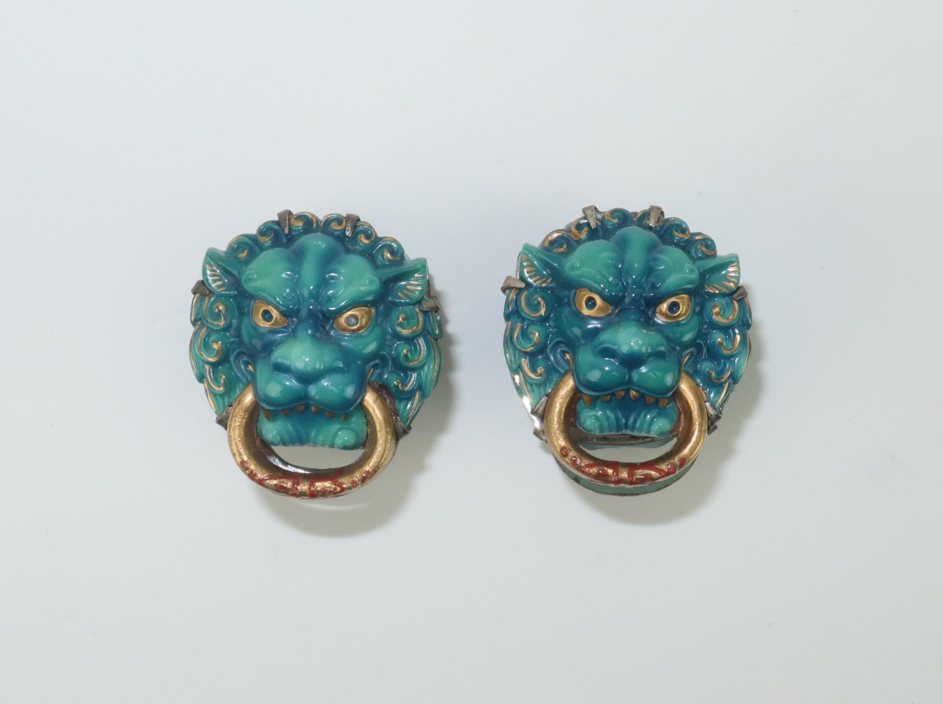 1950's Japanese porcelain foo dog cufflinks set in silver by the Toshikane Company.  The hand painted enameled porcelain foo dogs are incredibly detailed mixing shades of a deep aqua blue and gold with just a touch of red.  The unique cufflinks snap