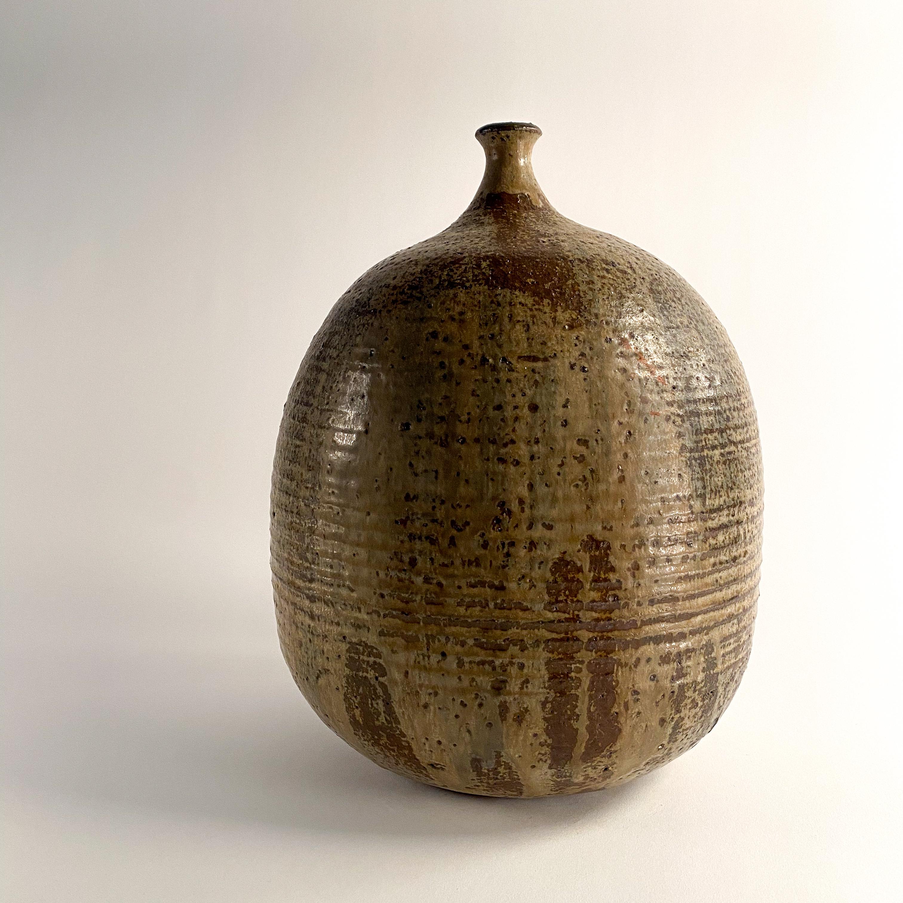 Beautiful ceramic vessel by Toshiko Takaezu.  this is an early bottle form, the glazing is consistent with this time period and the signature is also correct for the time period, which is last Cranbrook, early Cleveland (50's- 60's). the pot is 12