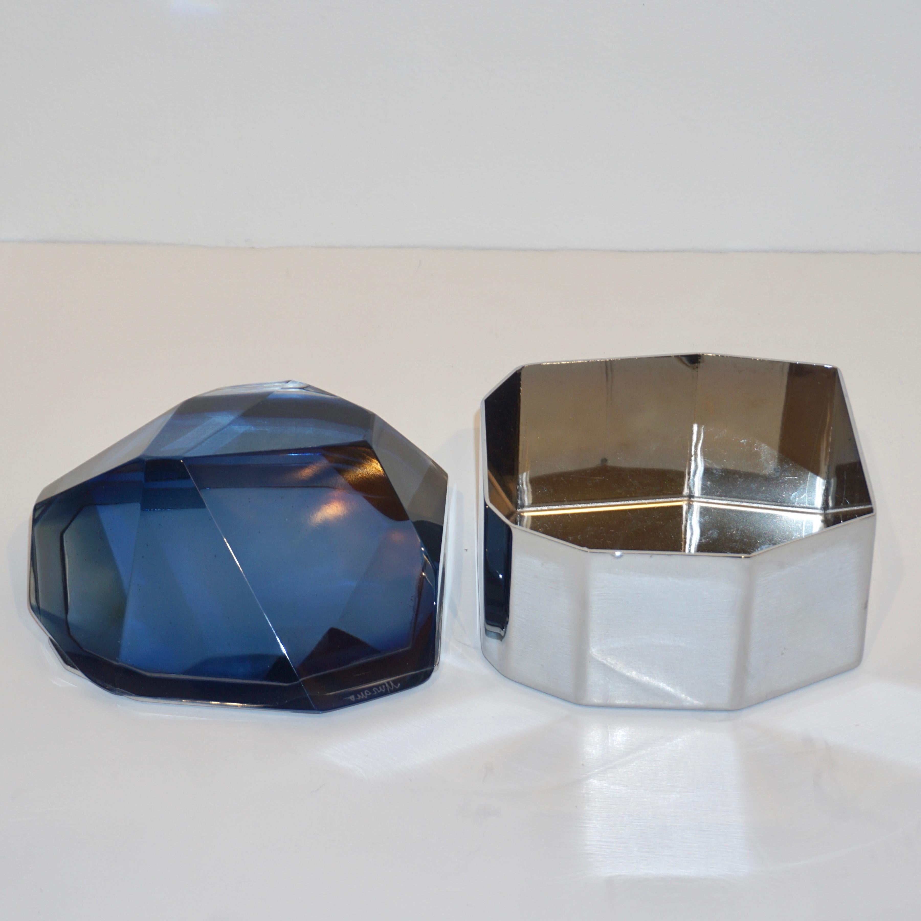 Italian contemporary organic casket, entirely handcrafted, by Toso Vetri d'Arte (signed Murano) with a freeform geometric nickel case embellished by a smoked midnight blue cover in blown rock Murano glass, handcut like a diamond. Available in other