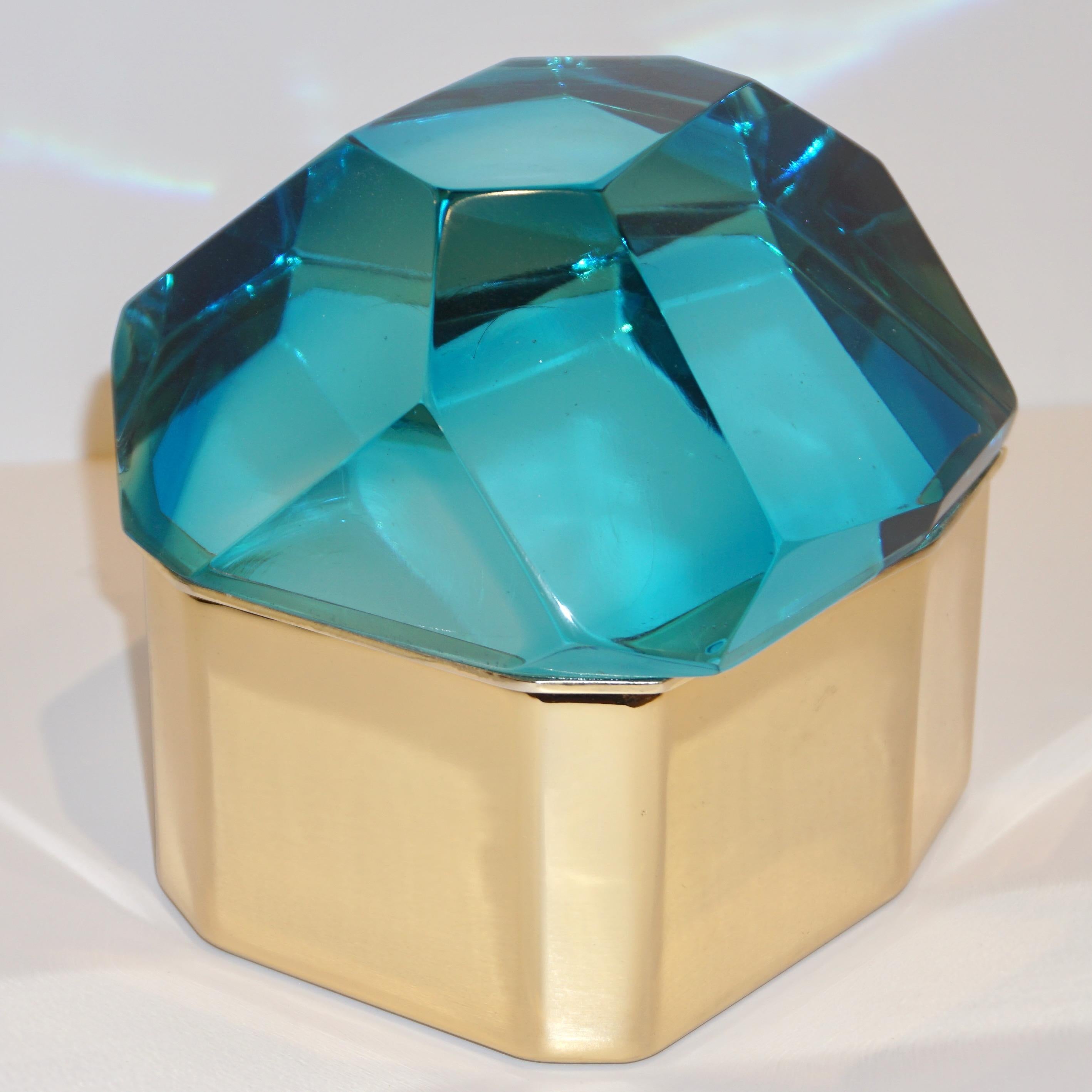 Italian contemporary organic casket, entirely handcrafted, by Toso Vetri d'Arte (Murano) with a freeform geometric brass case embellished by a turquoise blue cover in blown rock Murano glass, hand-cut like a diamond. Available also in Amber Gold and