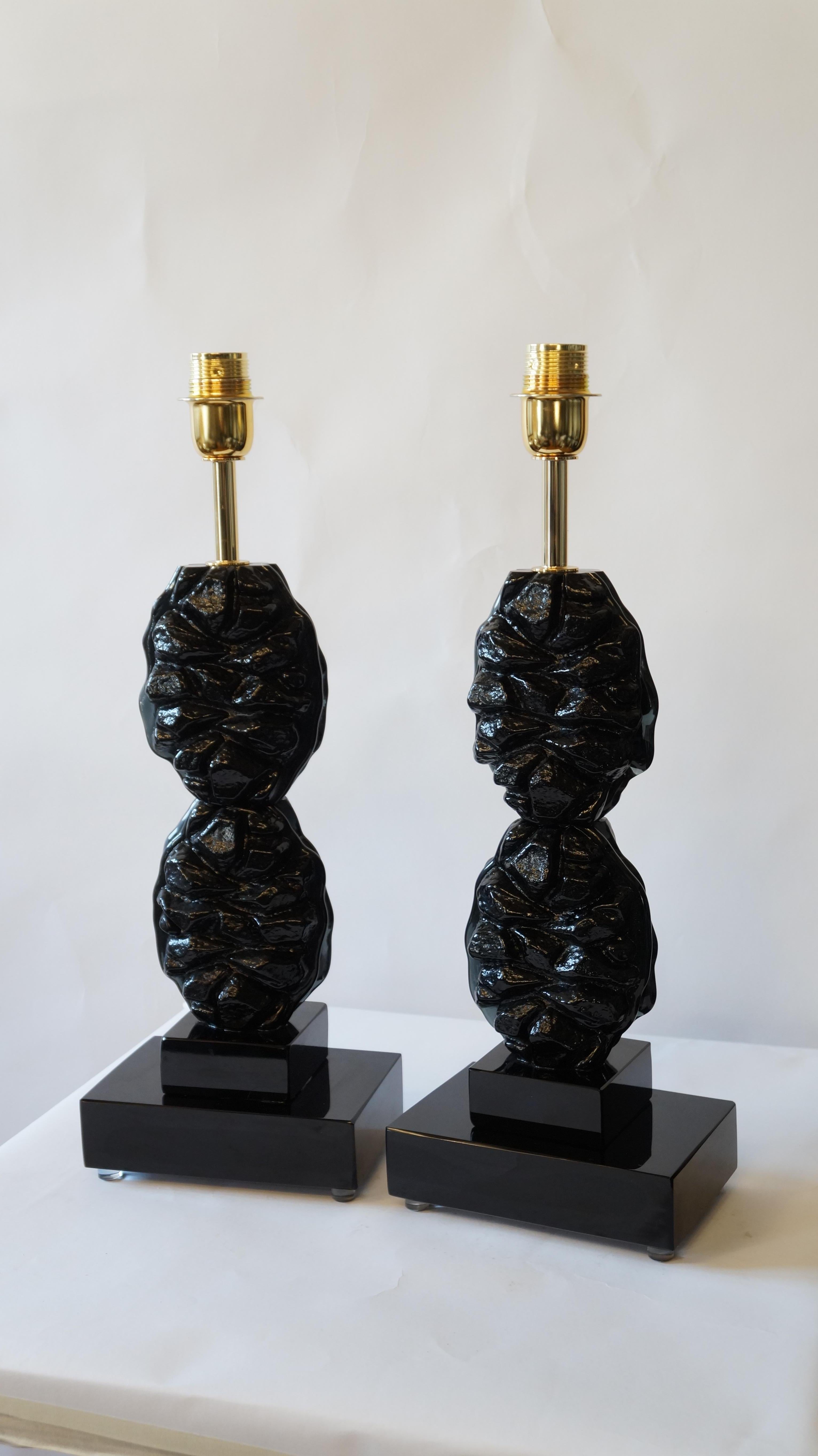 You have in front of you in the image you can see, two lamps made by Toso Murano in 1978. 
These lamps are very simple and characterized by the superimposition of this kind of glass with an icy touch, although in this case blacks. 
But they are