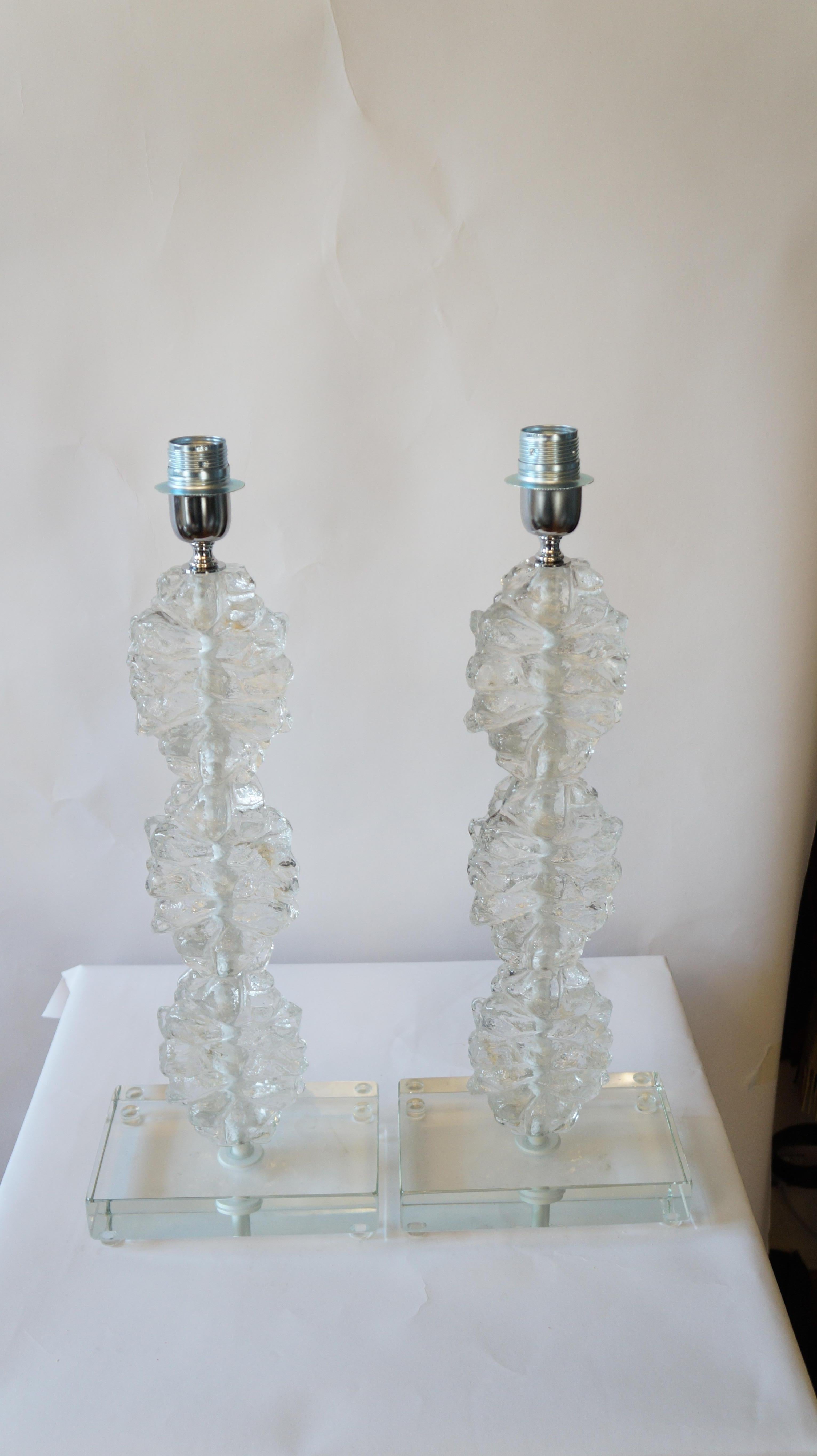 You have in front of you in the image you can see, two lamps made by Toso Murano in 1978. 
These lamps are very simple and characterized by the superimposition of this kind of glass with a glacial touch. 
But they are not as cold as ice, since,