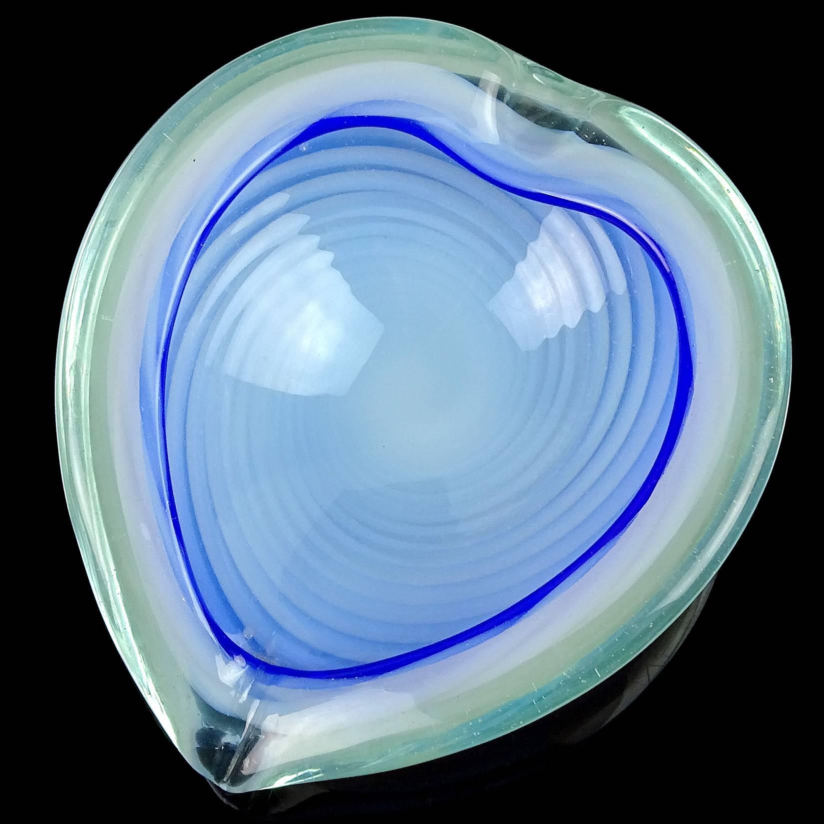 Beautiful large vintage Murano hand blown white opalescent swirl with blue rim Italian art glass heart shaped bowl. Documented to the Fratelli Toso company. Made with thick glass, with indents on the rim. Can be used as a display piece on any table.