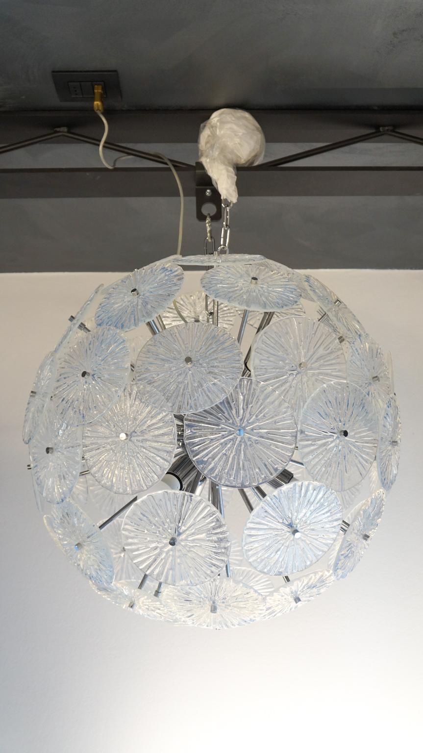 Fantastic Sputnik chandelier in blown Murano glass with 65 elements, crystal color. The chandelier can be reconditioned according to the country of destination. Six E27 / E26 bulbs. This chandelier is a project of the Murano glass master Stefano