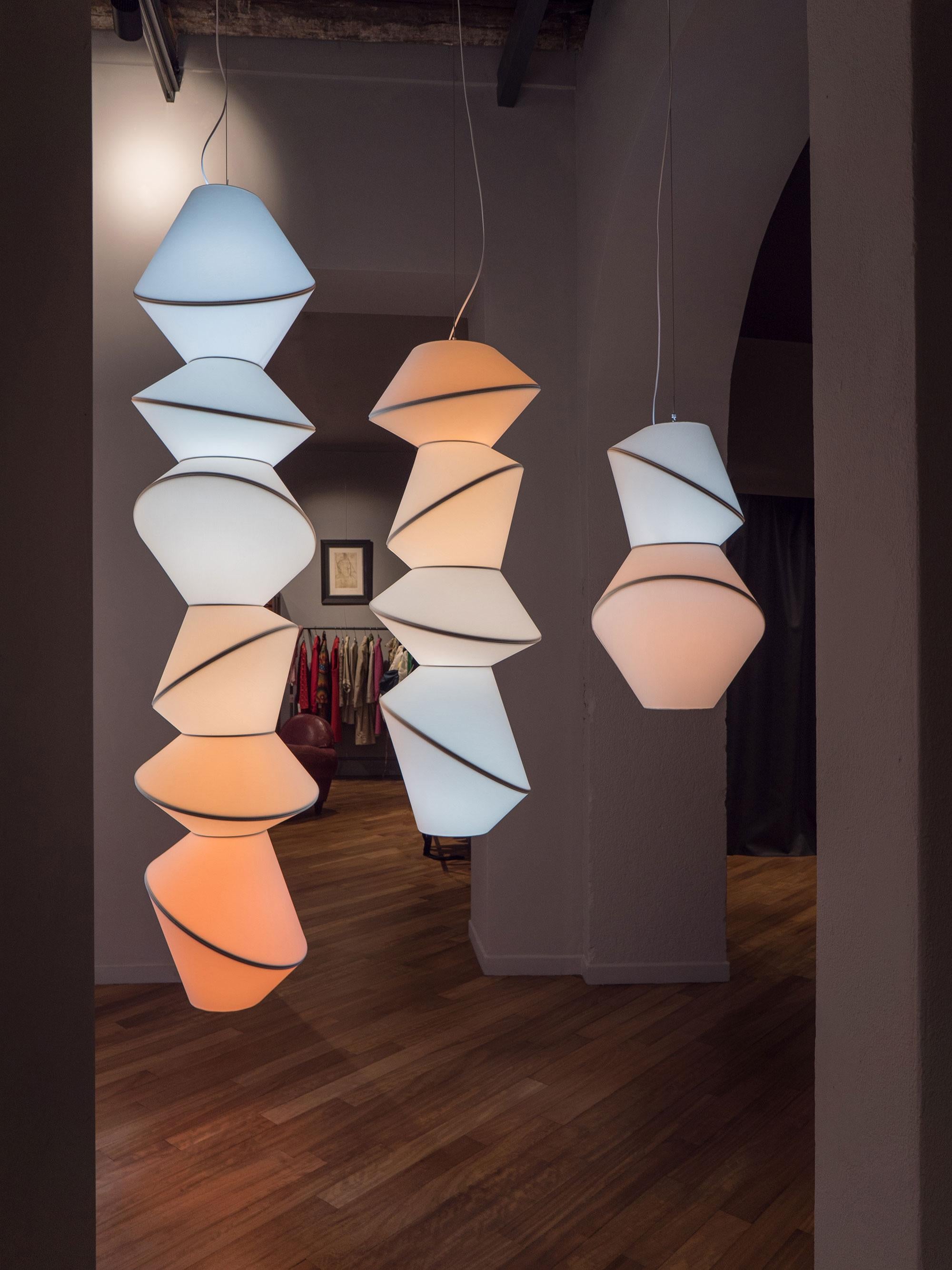 Totem 6 pieces ceiling lamp by Merel Karhof and Marc Trotereau
Dimensions: D50 x H221 cm.
Materials: Cotton laminated on pvc, powdercoated steel rings.

ShadeVolume 'The Kelvin Series'
‘The Kelvin Series’, five enlightened Totems in a gradient