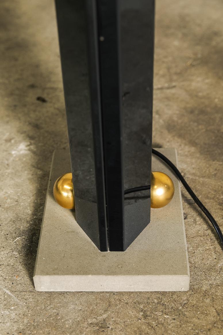TOTEM floor lamp design by Kazuhide Takaham for Sirrah in collaboration with Dino Gavina, 1982. The body is galvanized stainless steel in blue iridescent surface finish, and the base in sandstone.