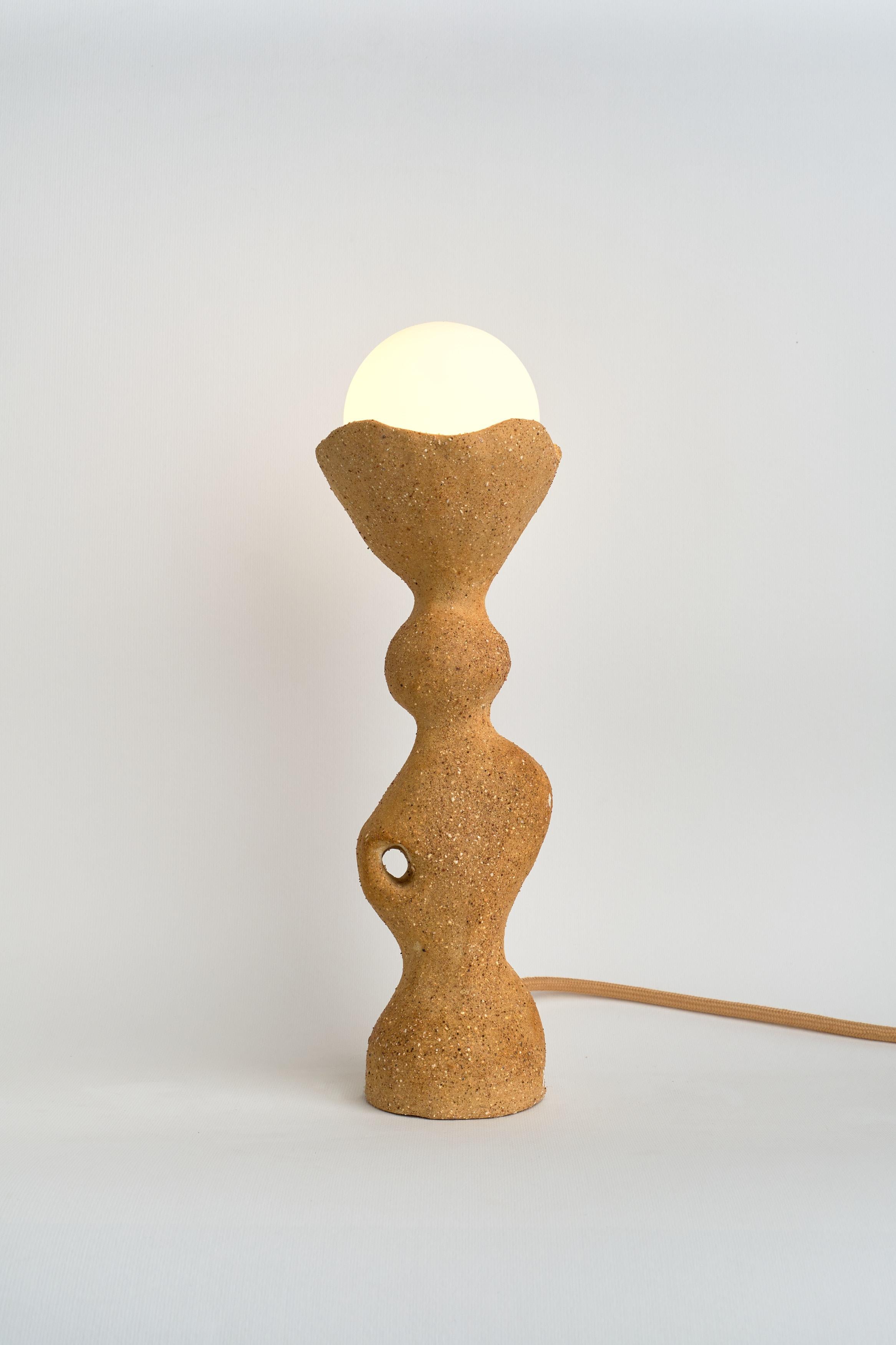 Totem I Table Lamp by Camila Apaez
Unique
Materials: Stoneware, Clay
Dimensions: ⌀ 10 x H 31 cm

Ila Ceramica emerged from a process of inner inquiry where ceramics became a space for presence, silence, touch and patience. Camila discovered the
